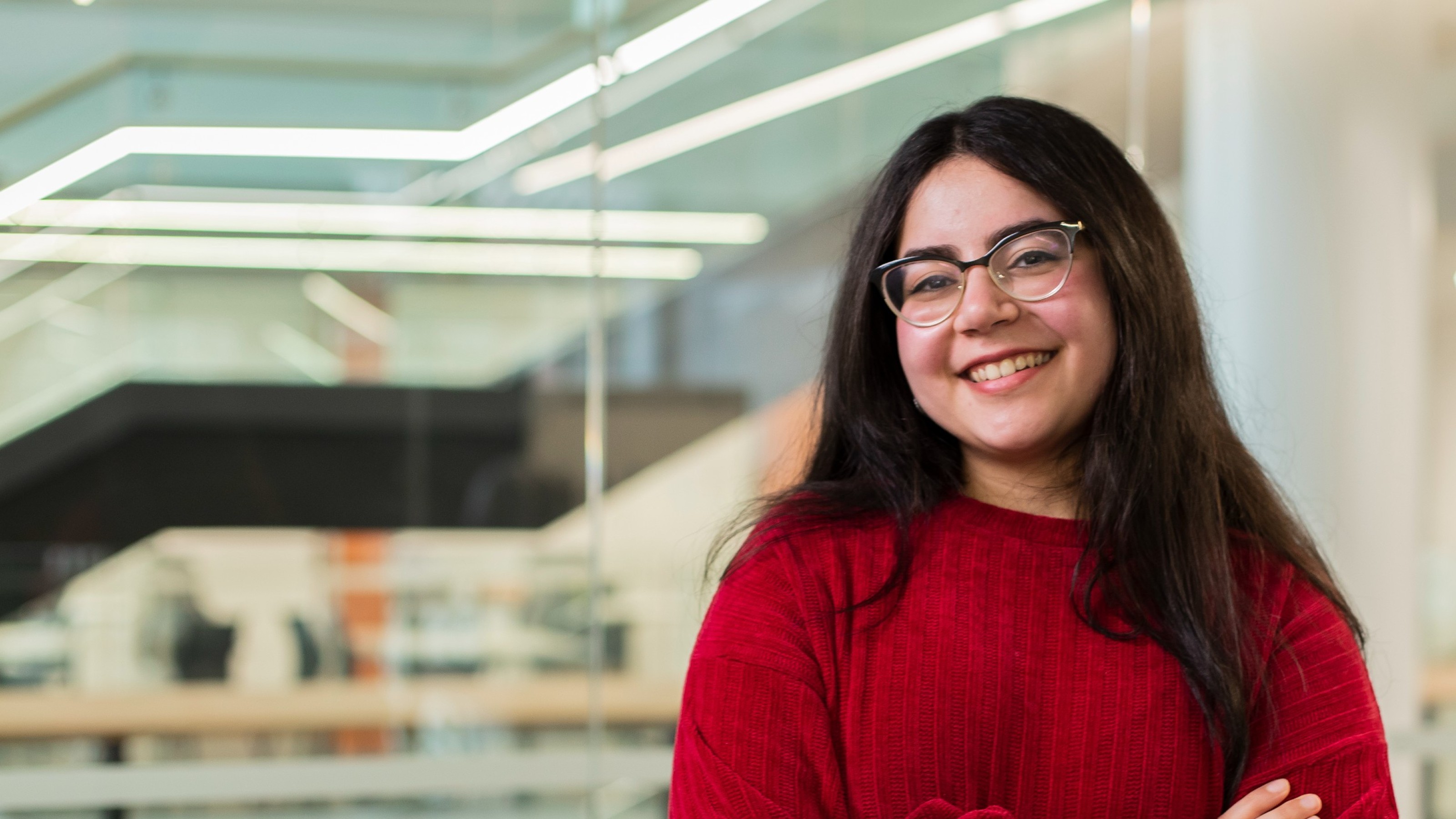 Woman wearing glasses and a red sweater.