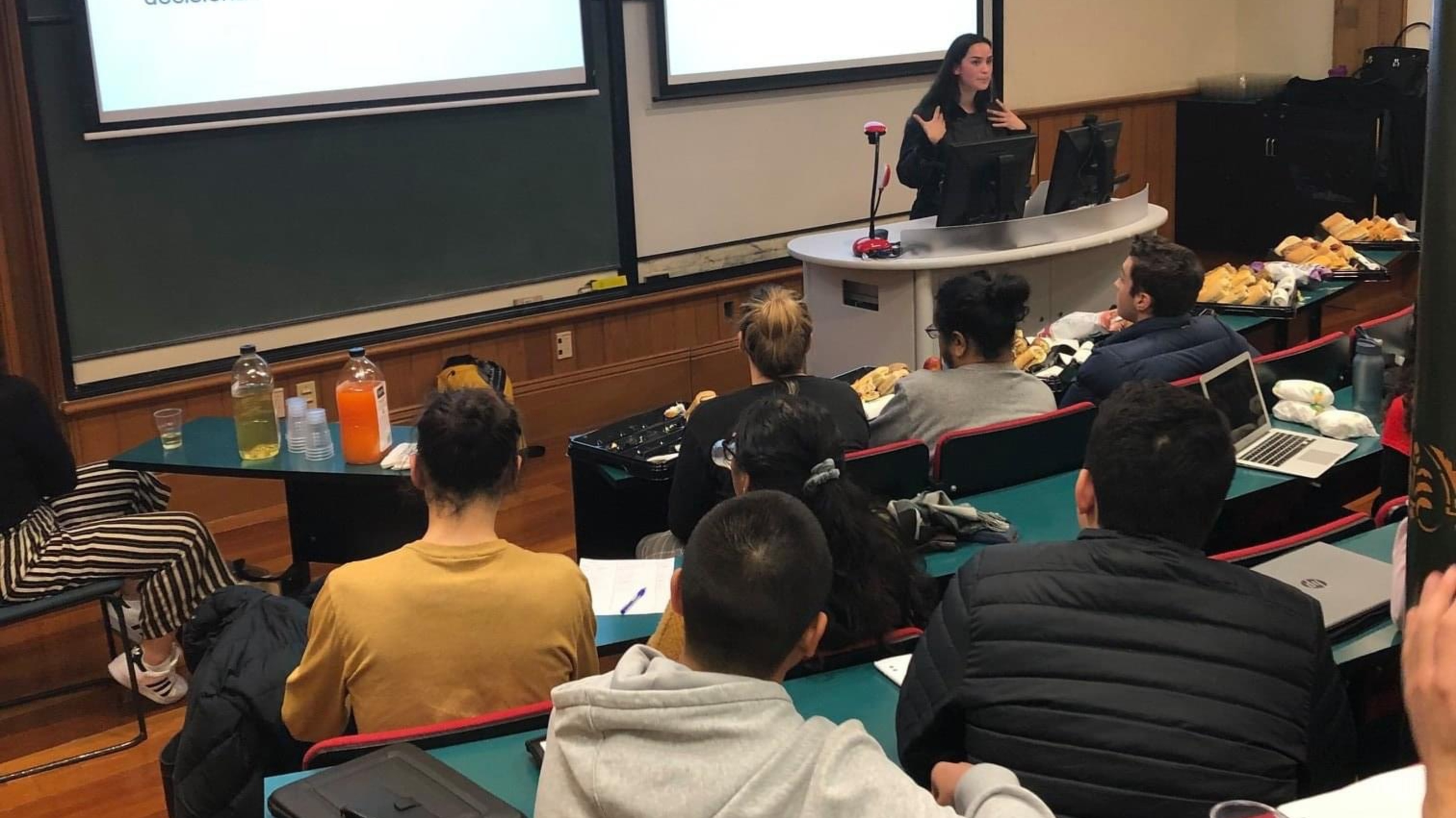 Students sitting in lecture theater, listening to speaker during workshop.