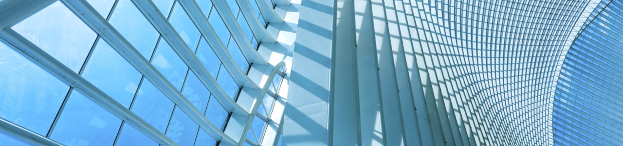 Banner image of a tall atrium with many pieces of glass.