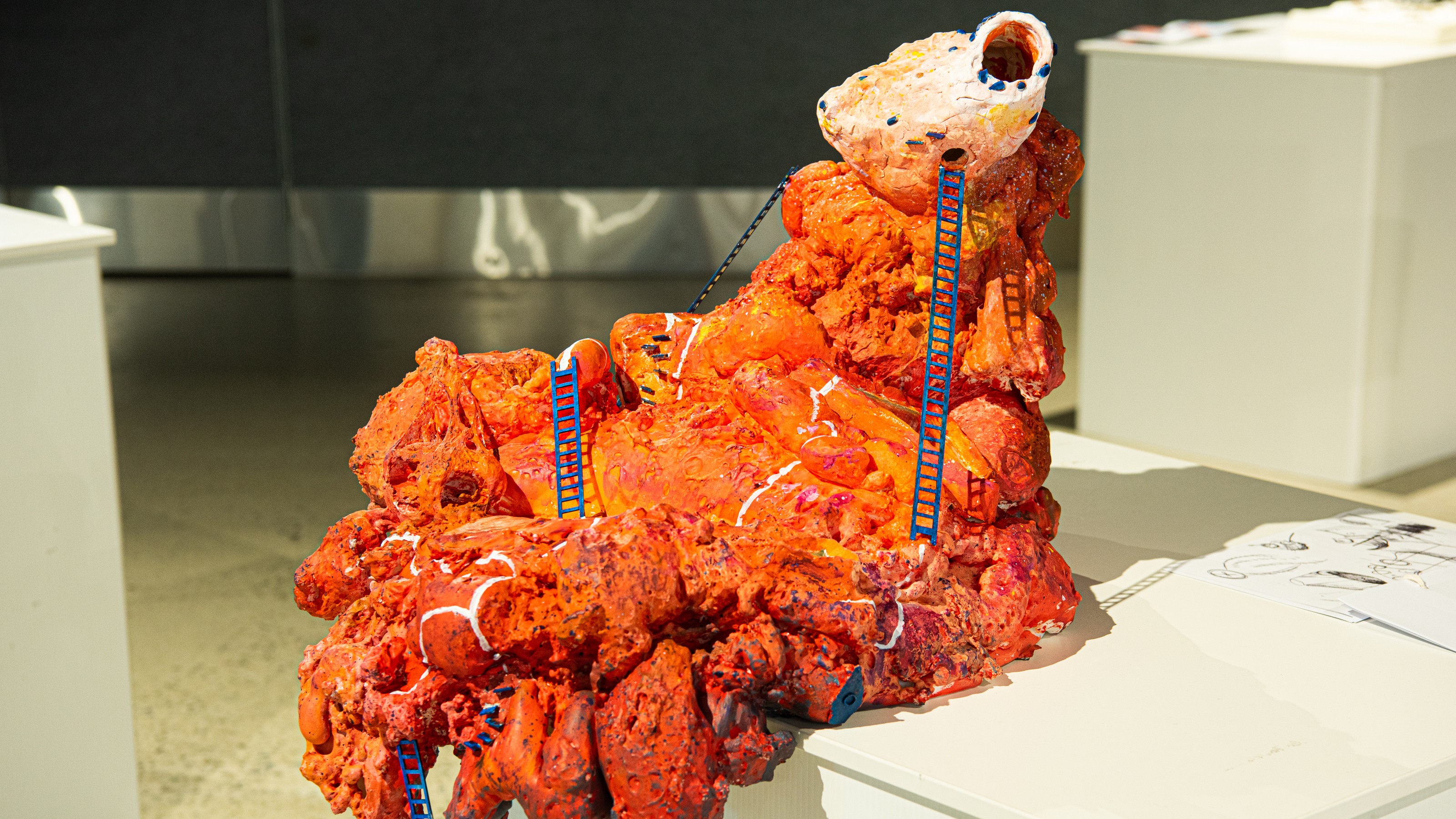 Orange organic looking architectural model from Collective properties exhibition by SARC 261 elective students