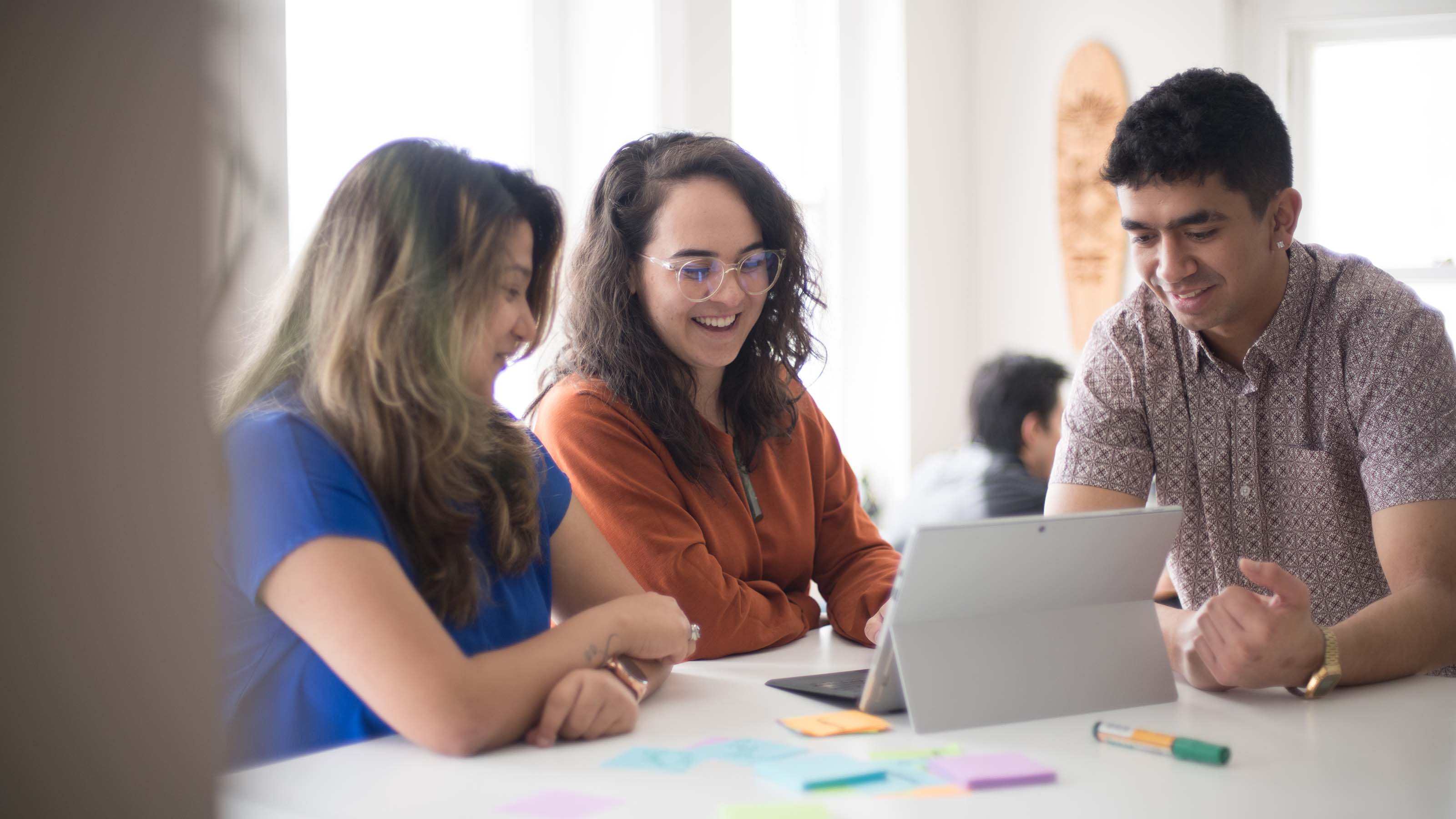 A group of students working at a desk.