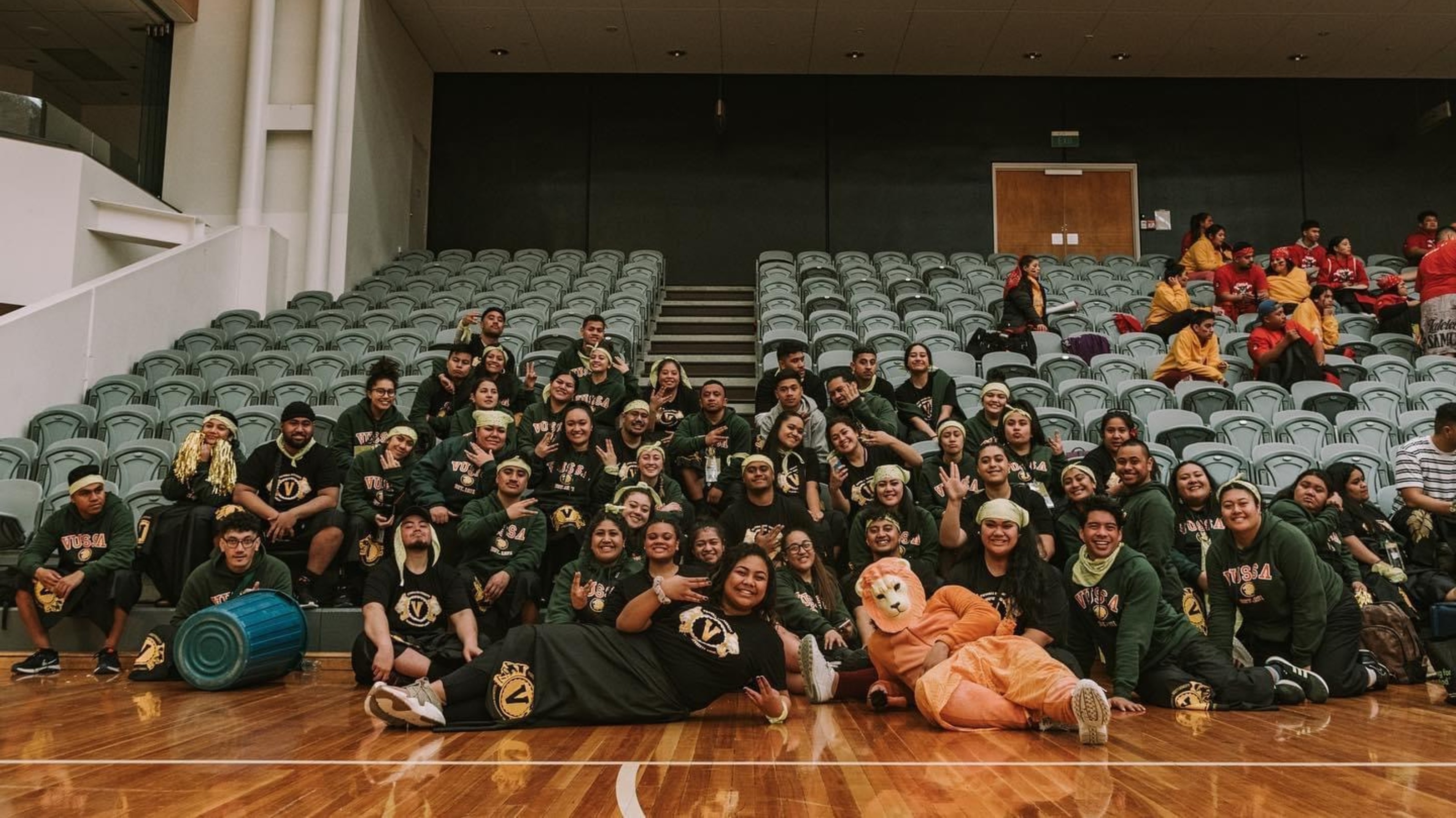 Sports group picture with lion mascot.