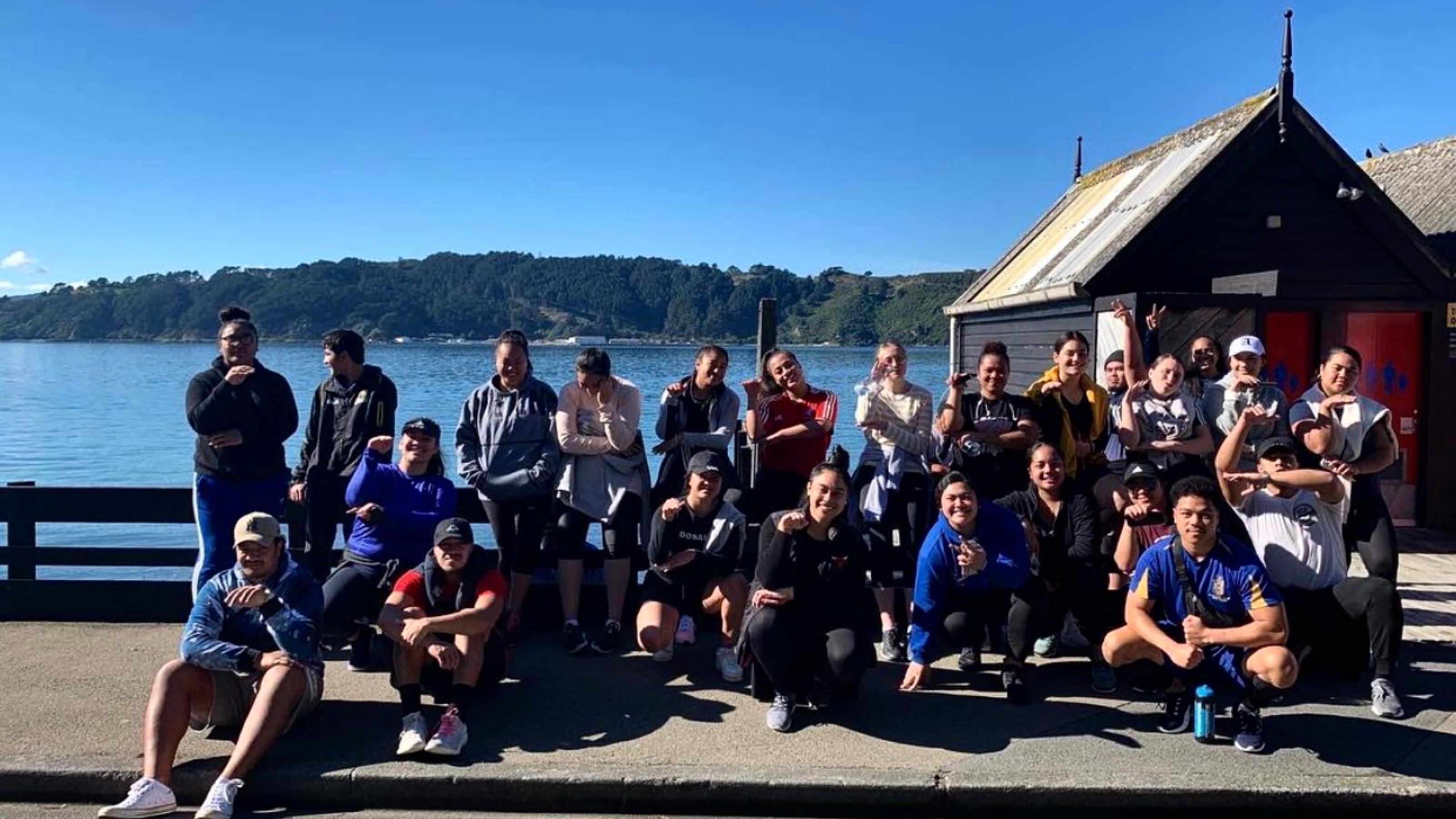 Students by the sea after a marathon.