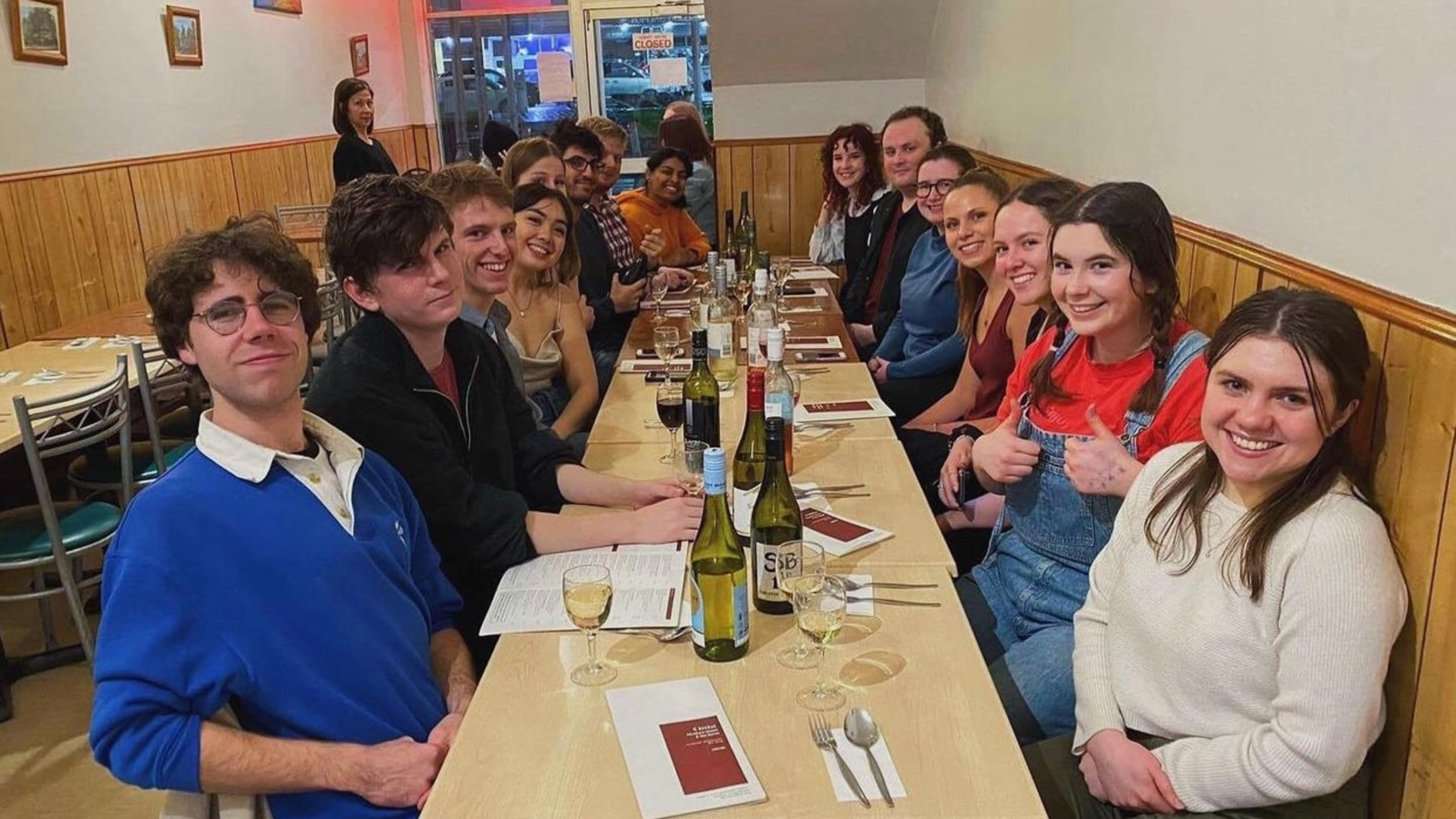 Society members having dinner together at restaurant.