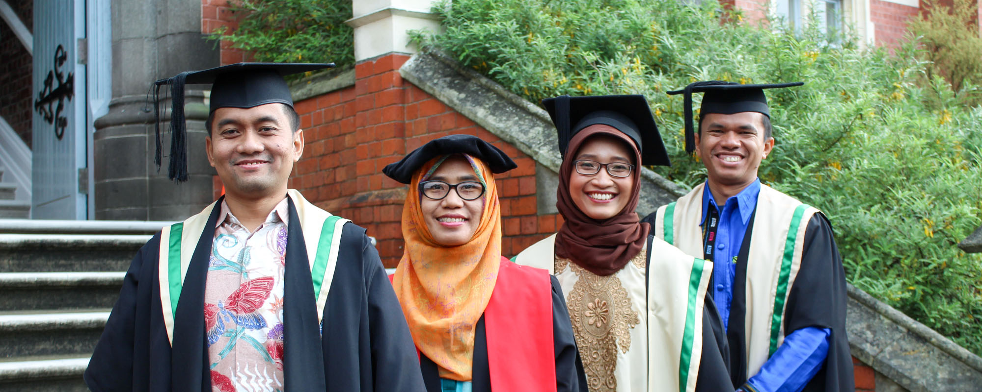 NZSP graduates after ceremony in front of Kirk building.