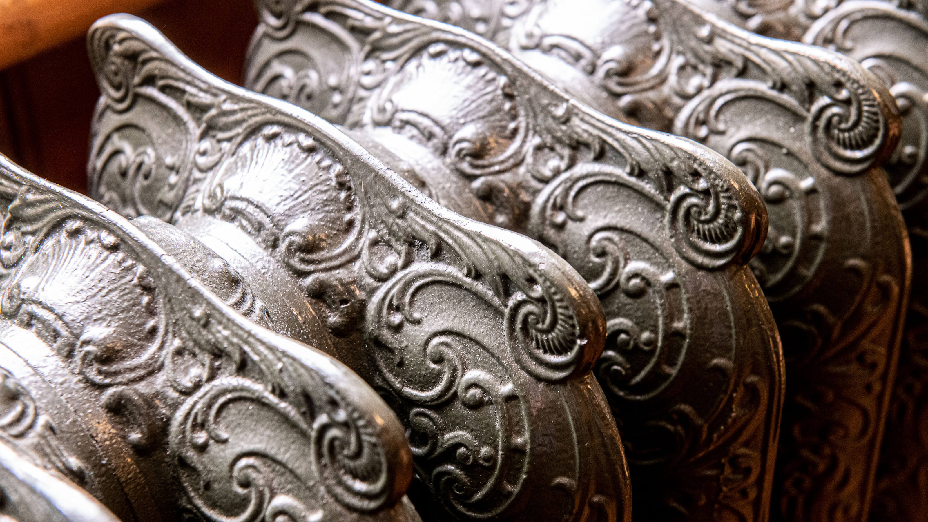 Close up of metal radiators with ornate Victorian decorations.
