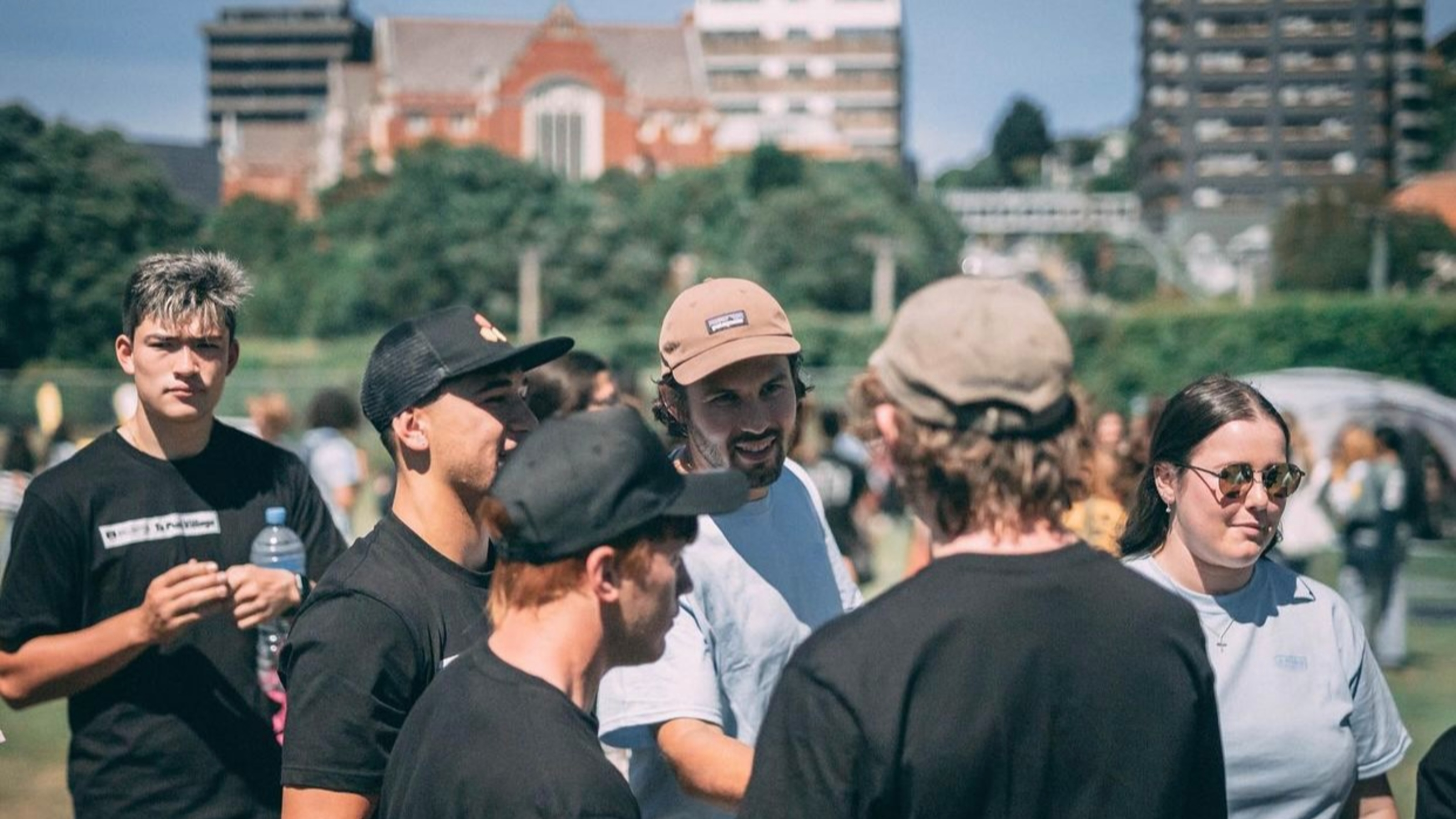 Students on green field during open day, with Hunter building in background.