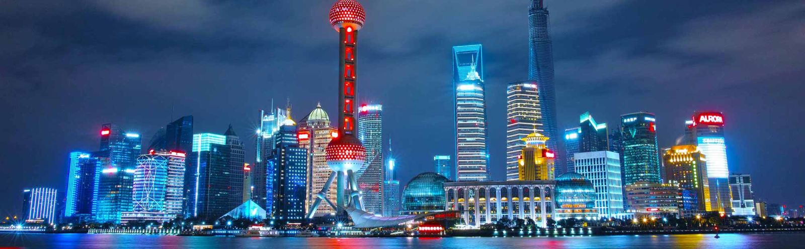 A cityscape image of Shanghai at night.