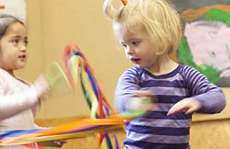 Two girls dancing with ribbons.