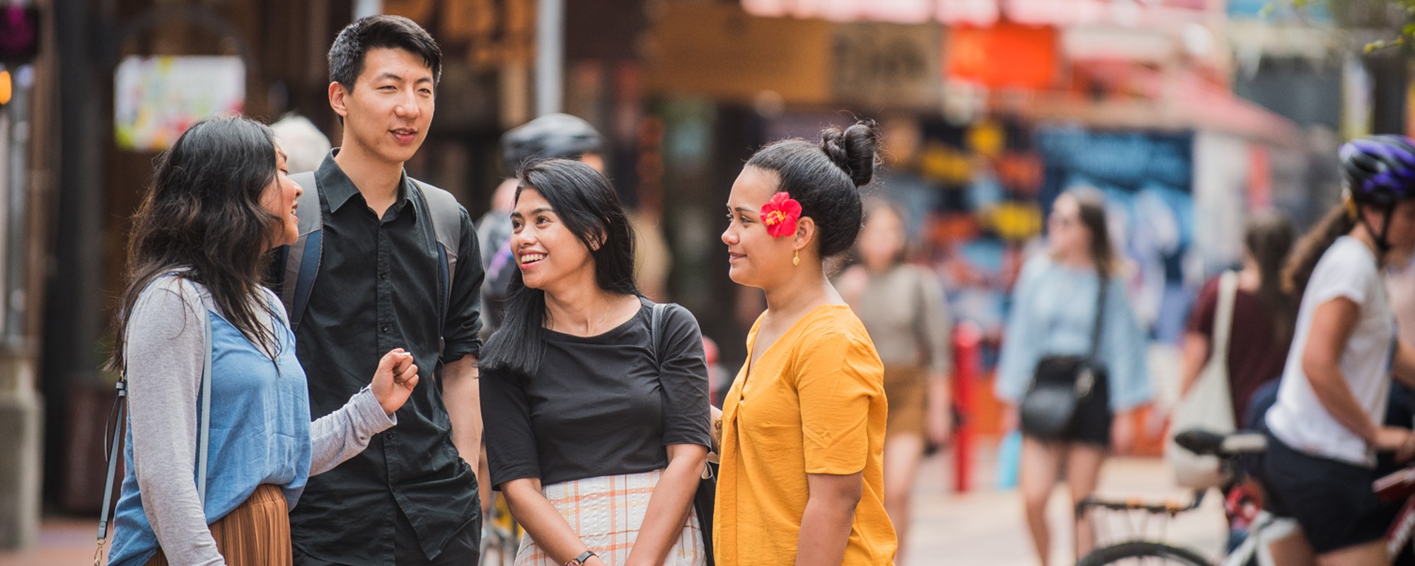 Students in the middle of a colourful street deciding where to go