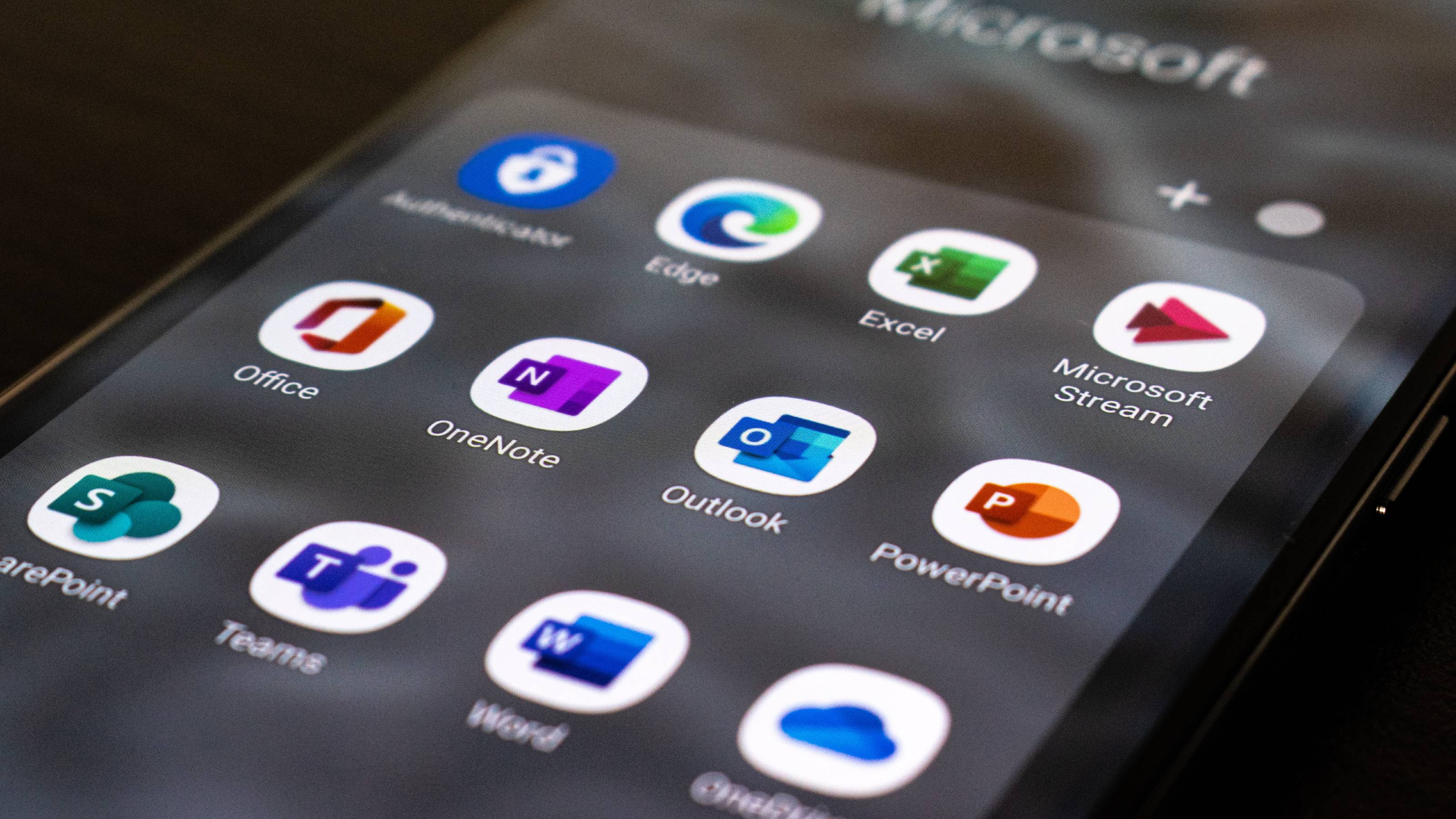 Icons for Microsofts apps displayed on a cell phone screen.