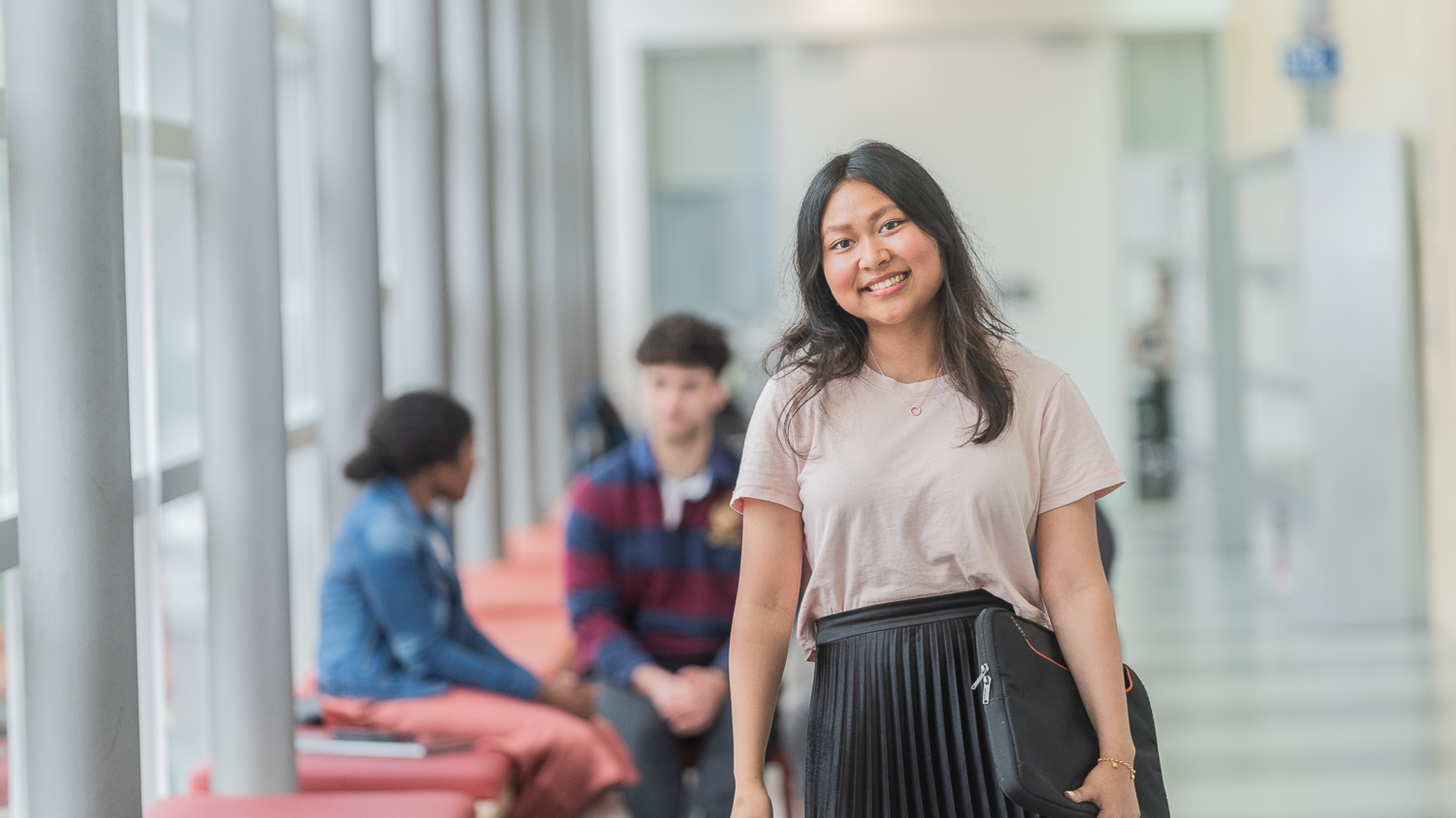 A student standing in a corridor at Rutherford House