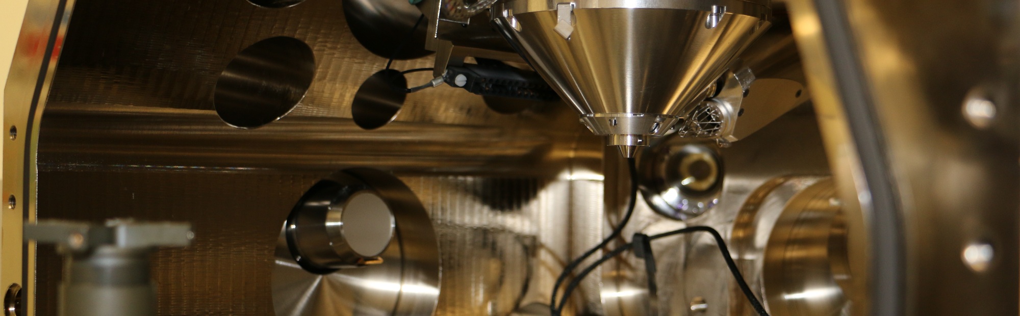 Detail of a shiny metal device for magnetron sputtering of magnetic films.