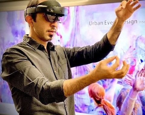 Hossein in VR headset A man in a black shirt, wearing a VR headset, holds an imaginary thread between the fingers of each hand.
