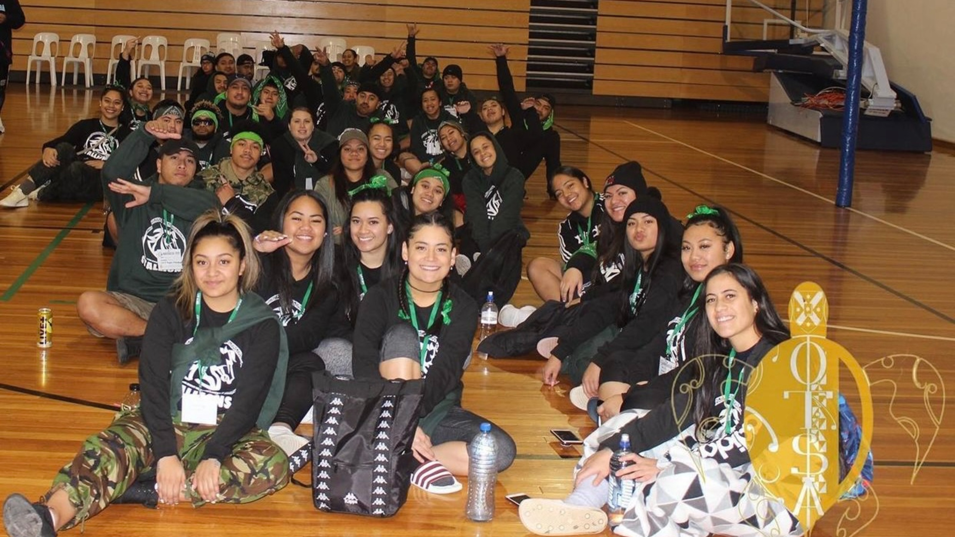Association members sitting on floor of sports hall.