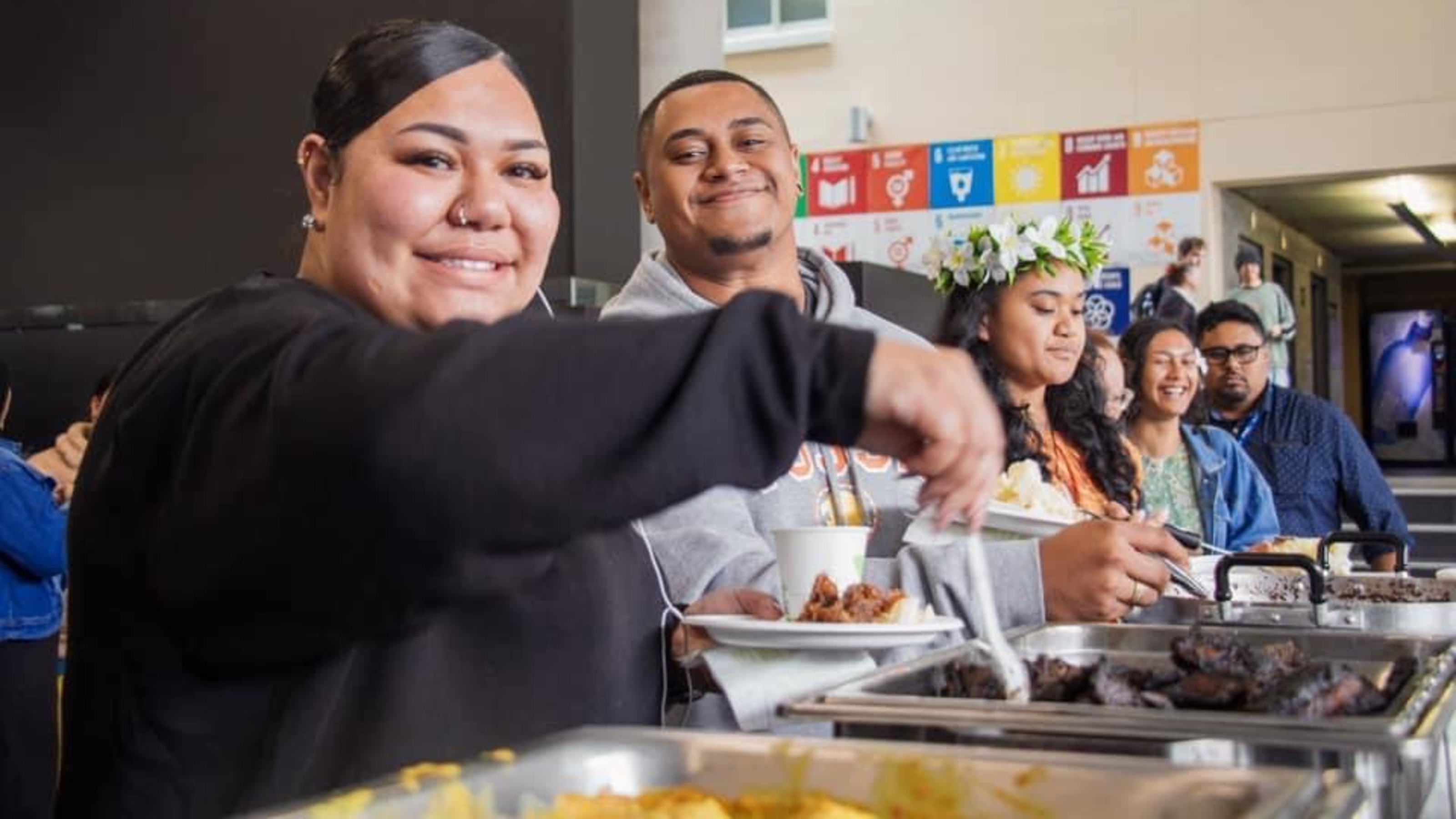Students filling their plates at a buffet in the Hub.