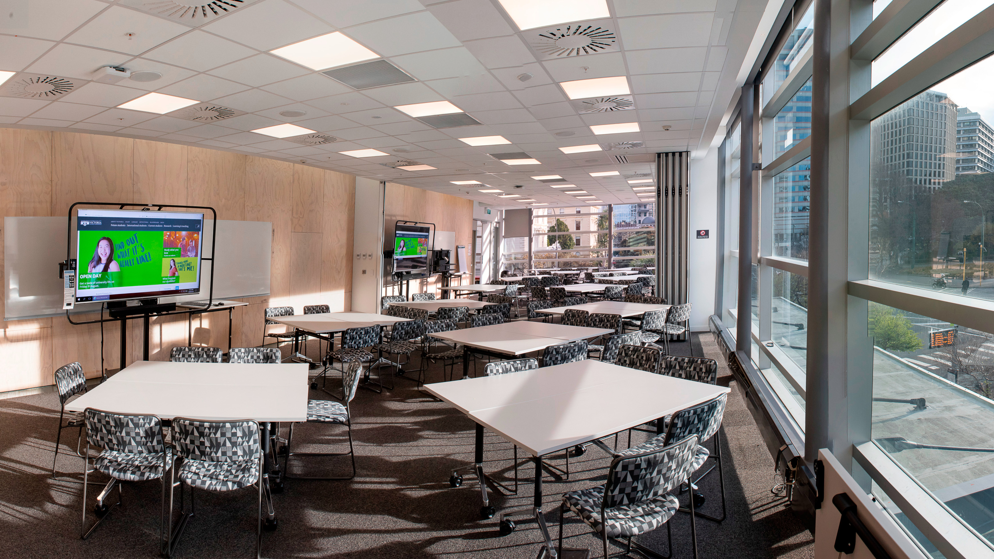 Rutherford House mezzanine seminar room, with sets of tables and four chairs