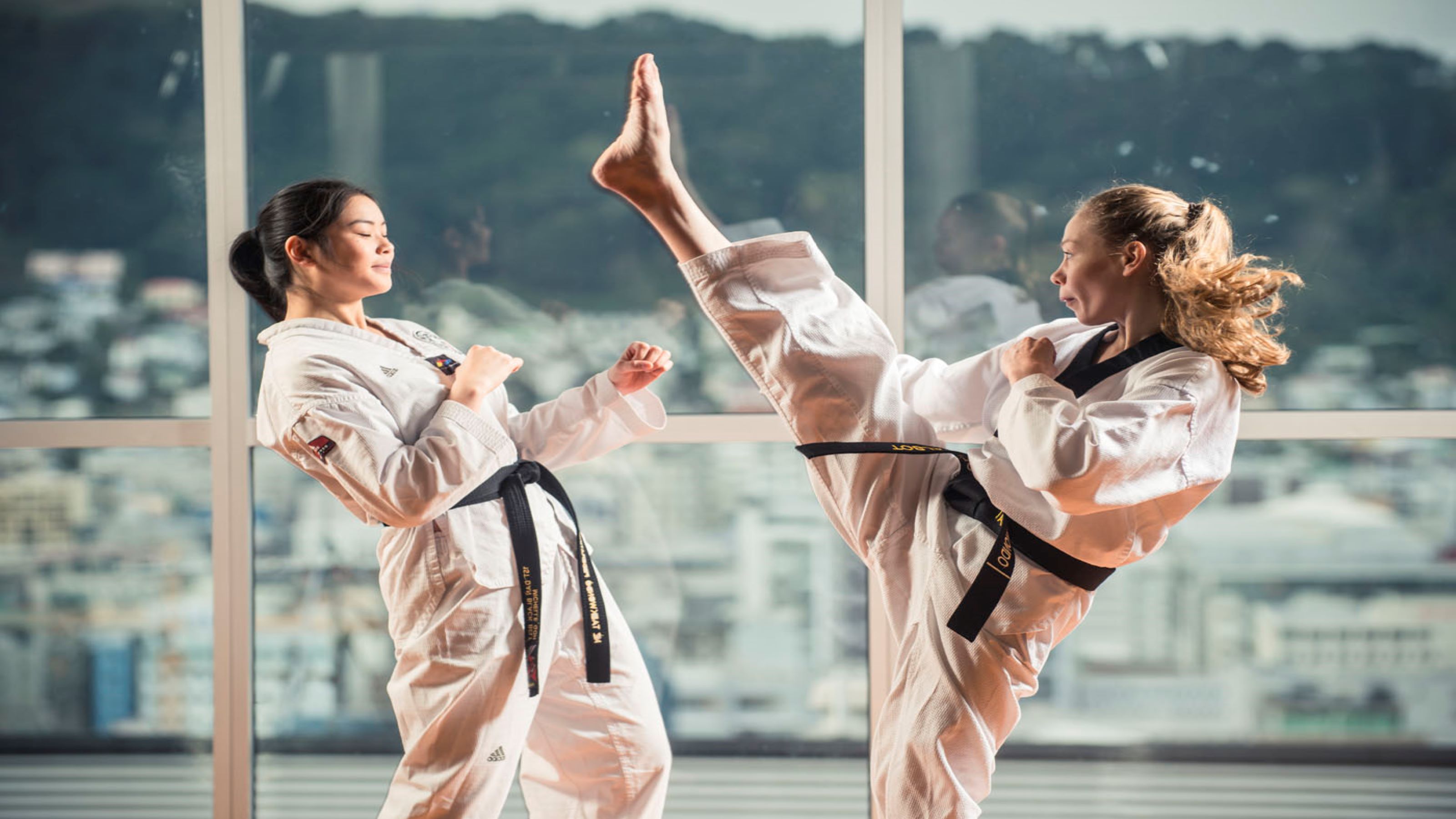 Taekwondo match between two female students.