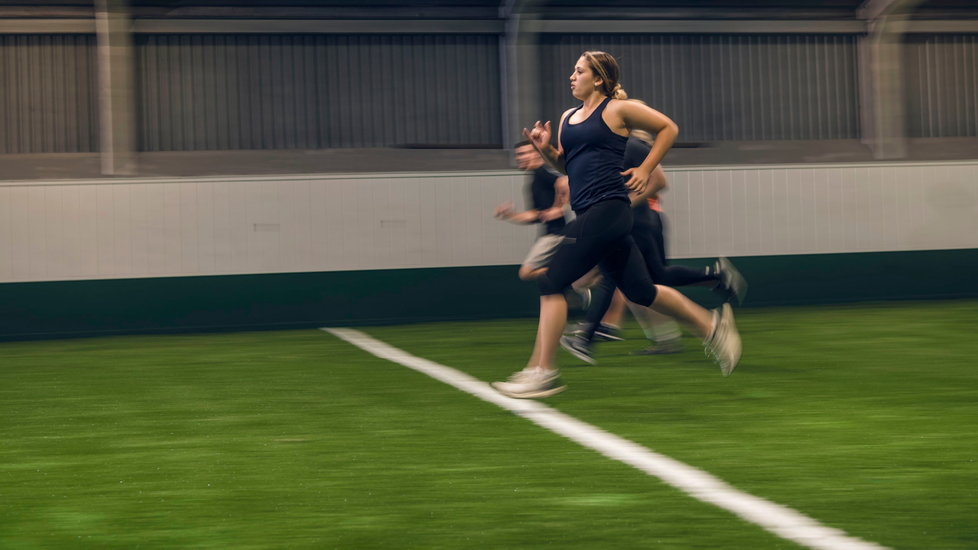 Students sprinting through the Boyd-Wilson arena.