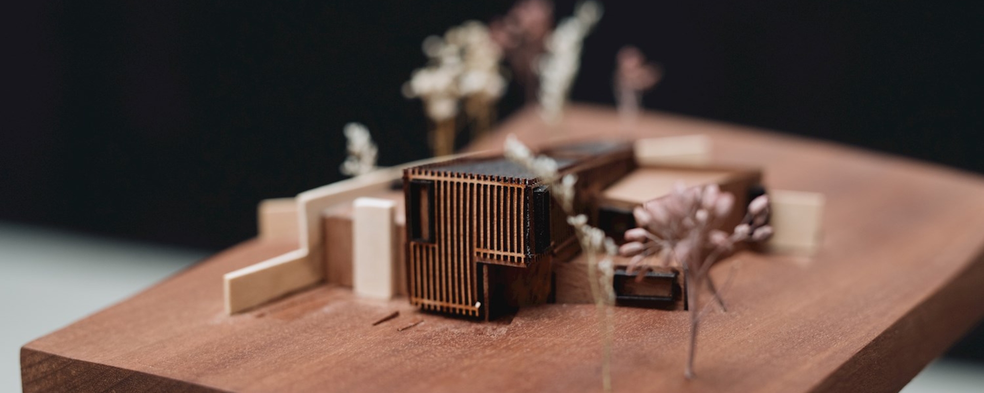 Close up of miniature architectural model on wooden display stand