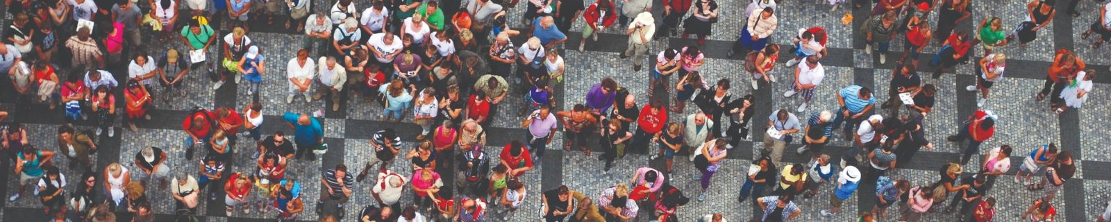 An aerial shot looking down on people gathered in a paved area