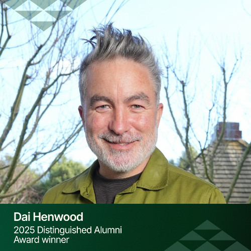 DAA 2025 Dai Henwood A close up of a smiling Dai Henwood with grey hair and a bright green shirt.