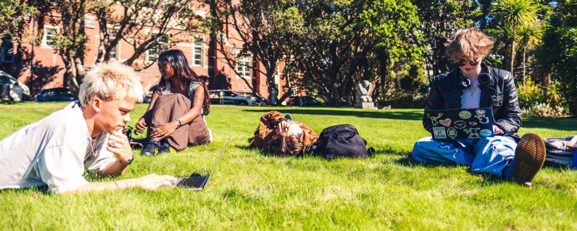 Group of students studying on the grass of the Hunter lawn.