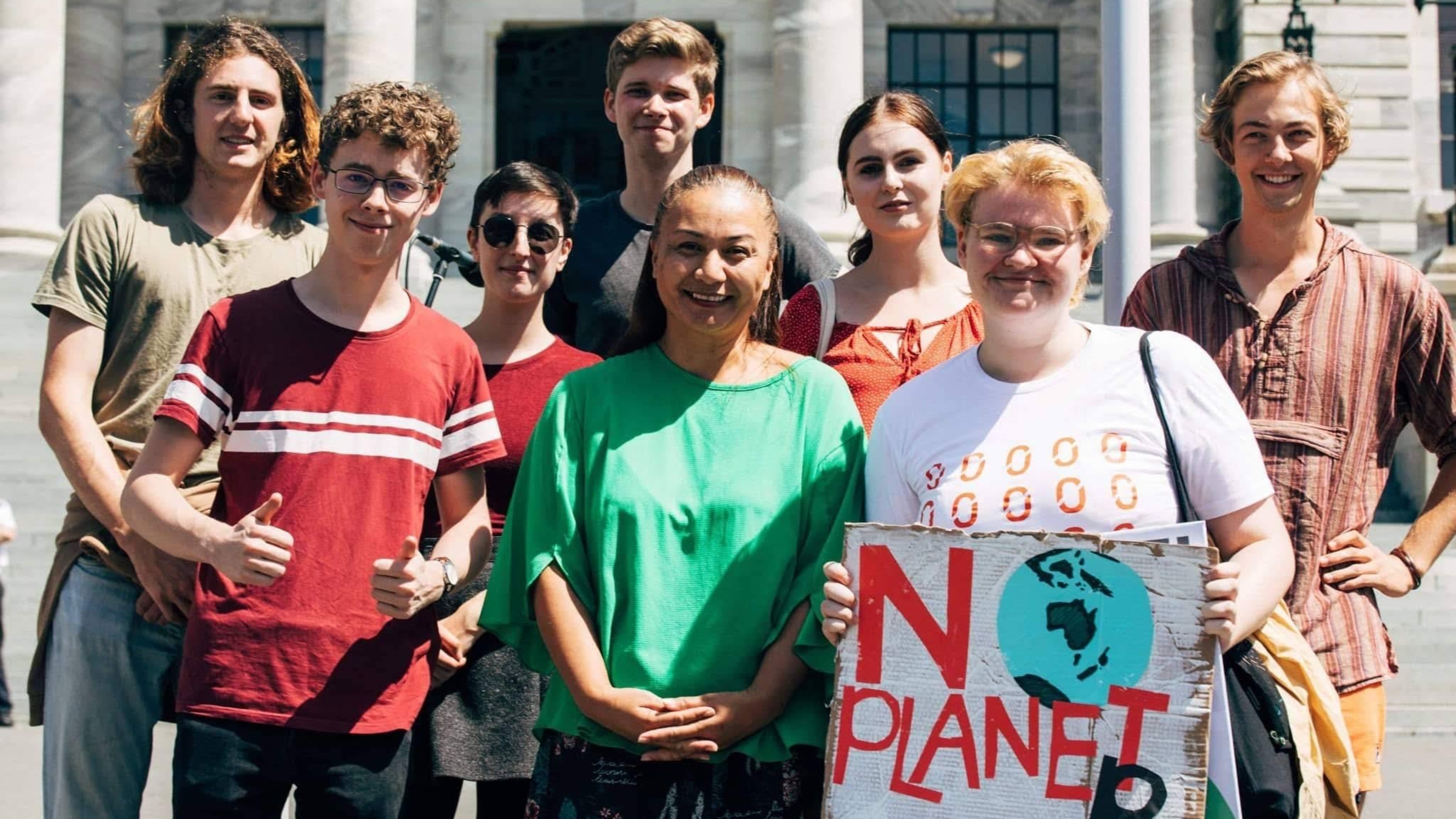 Students standing outside of the Parliament with Marama Davidson.