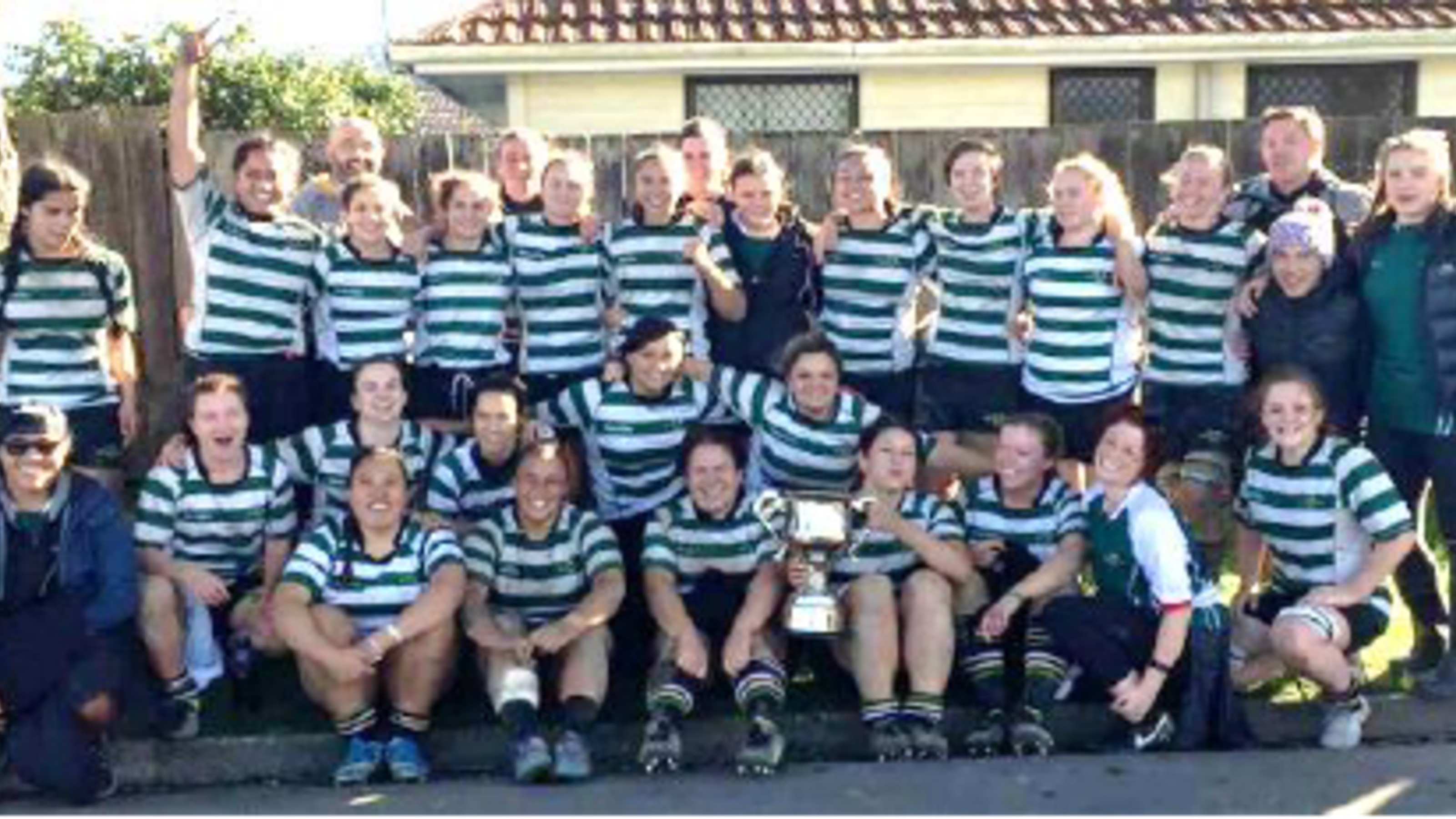Group picture of OBU women's team, in rugby gear and team jerseys.