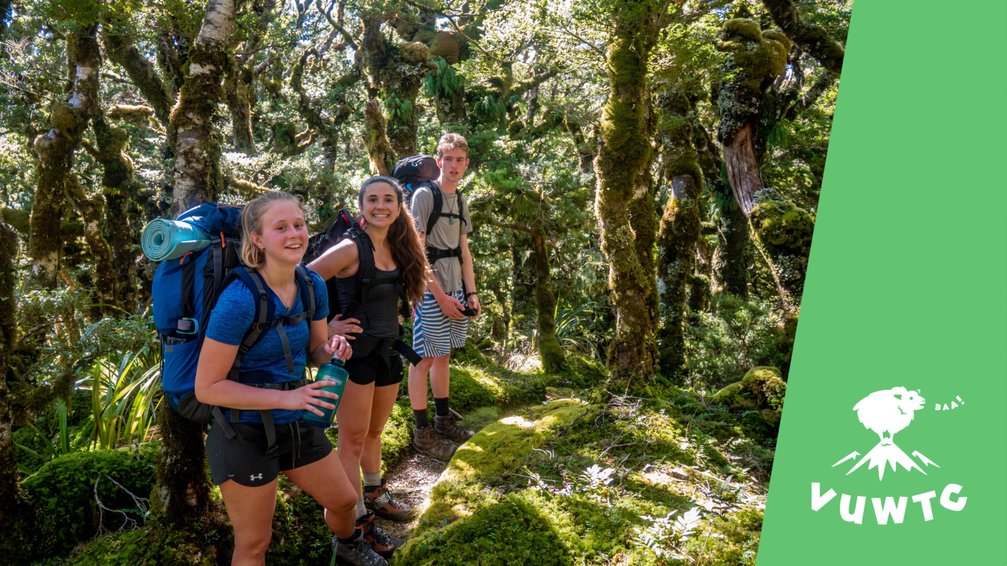 Trampers taking a drinking break in forest covered in moss/