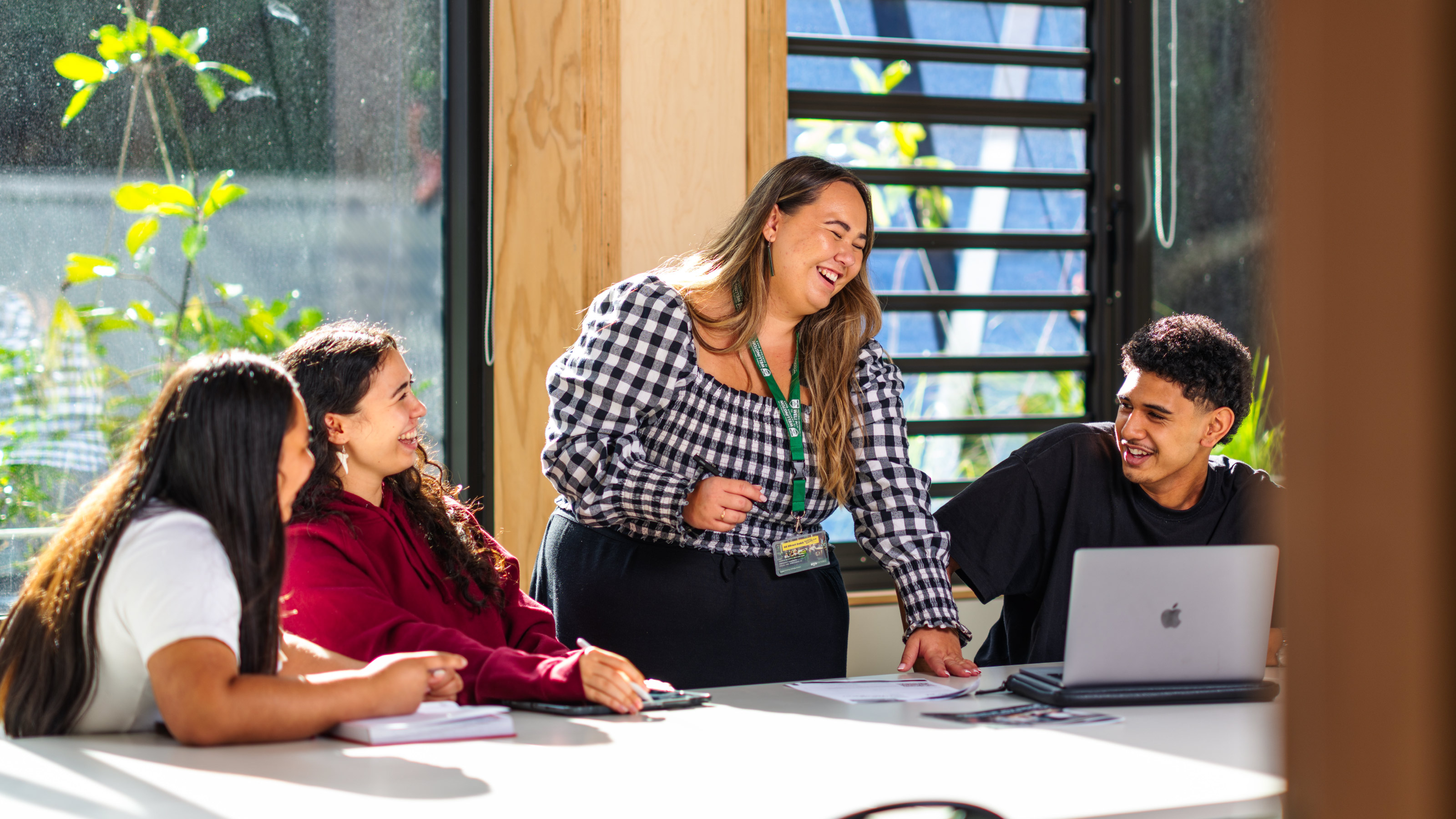 Tutor laughing with students