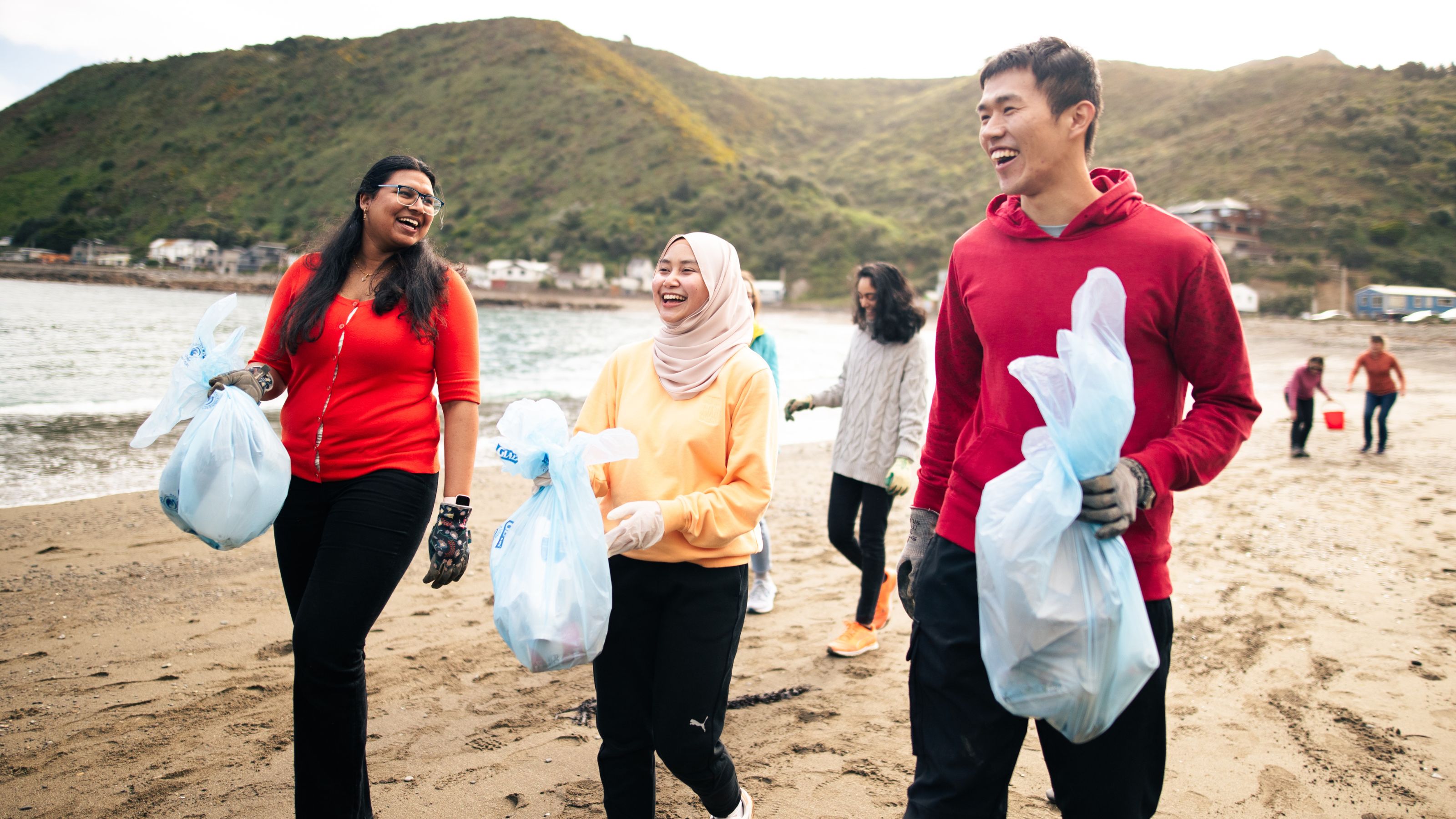 Student volunteering to clean up a beach