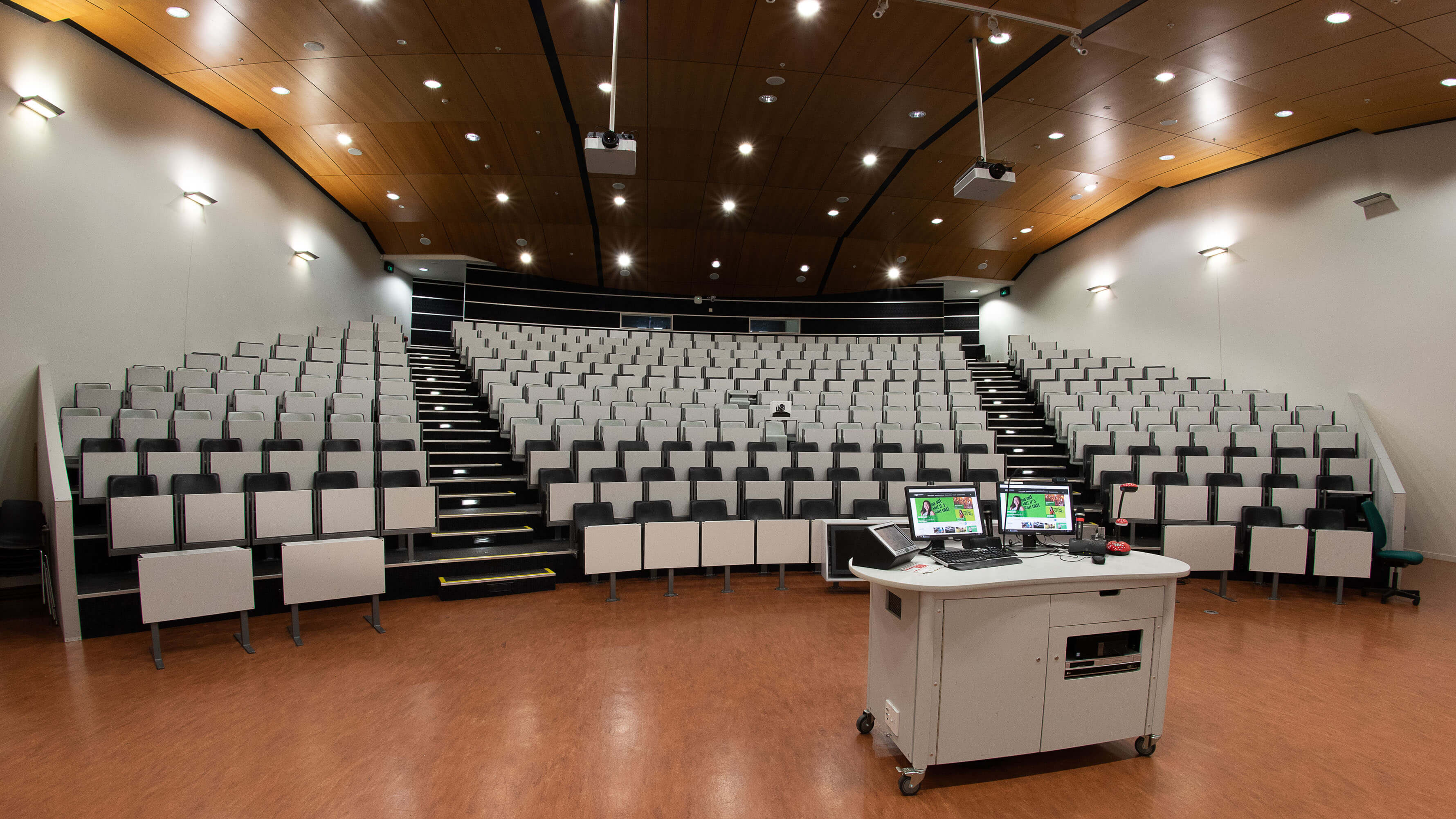 Rutherford House lecture theatre captured from where the speaker stands and looking out at many grey chairs and bright lights.