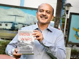 arjun-web.jpg Arjun holding a book titled, India Wars.