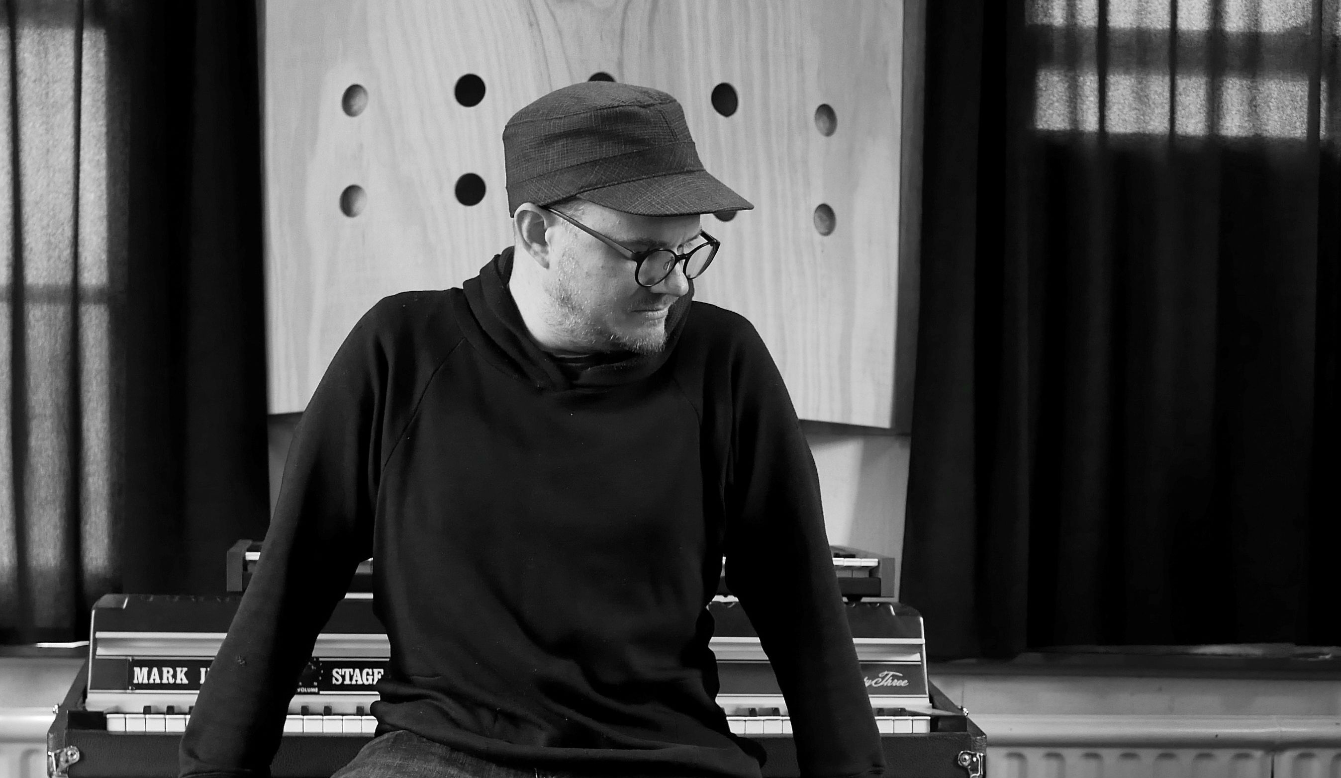 A black and white image of Thomas Voyce at a keyboard.