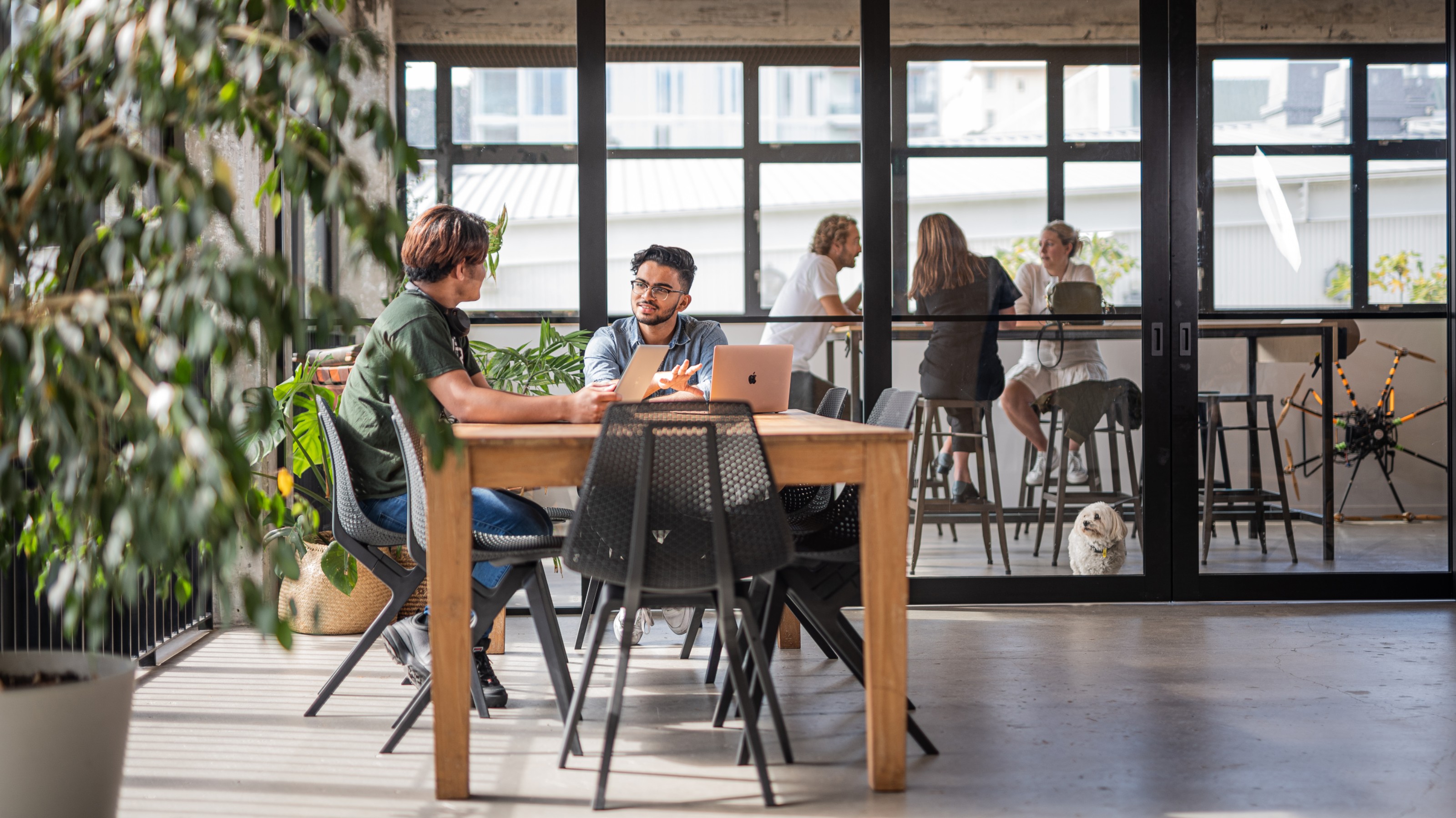 Tutor and student discussing work at a table