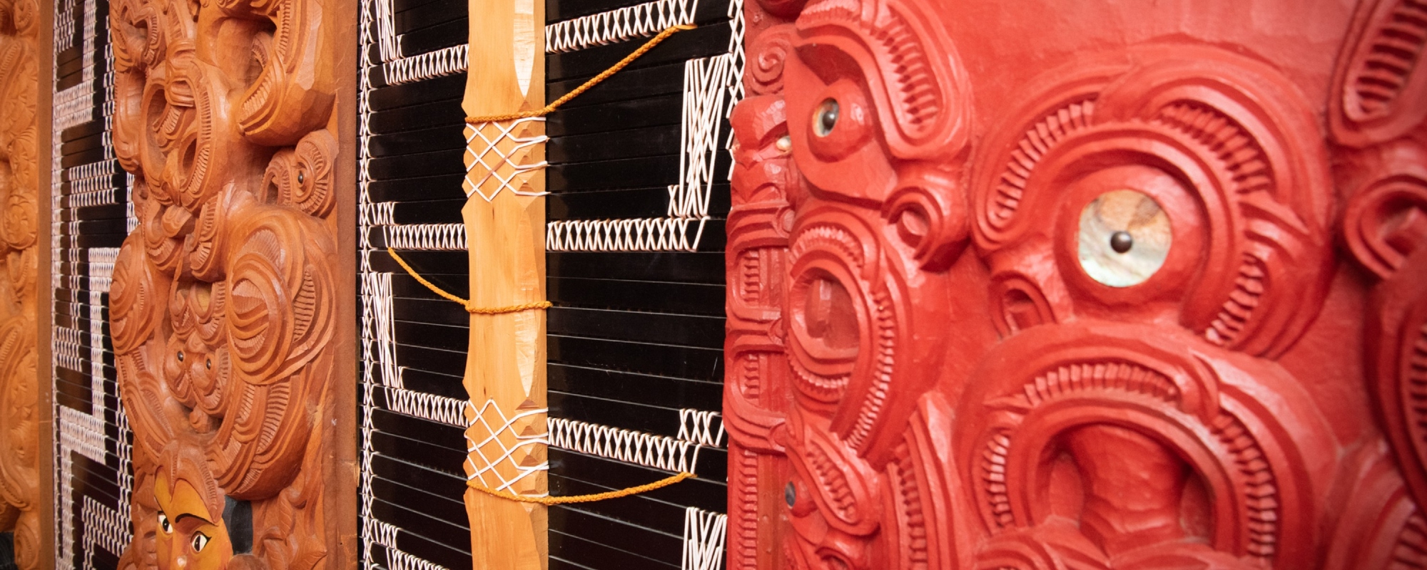 Wall made of Maori carvings.