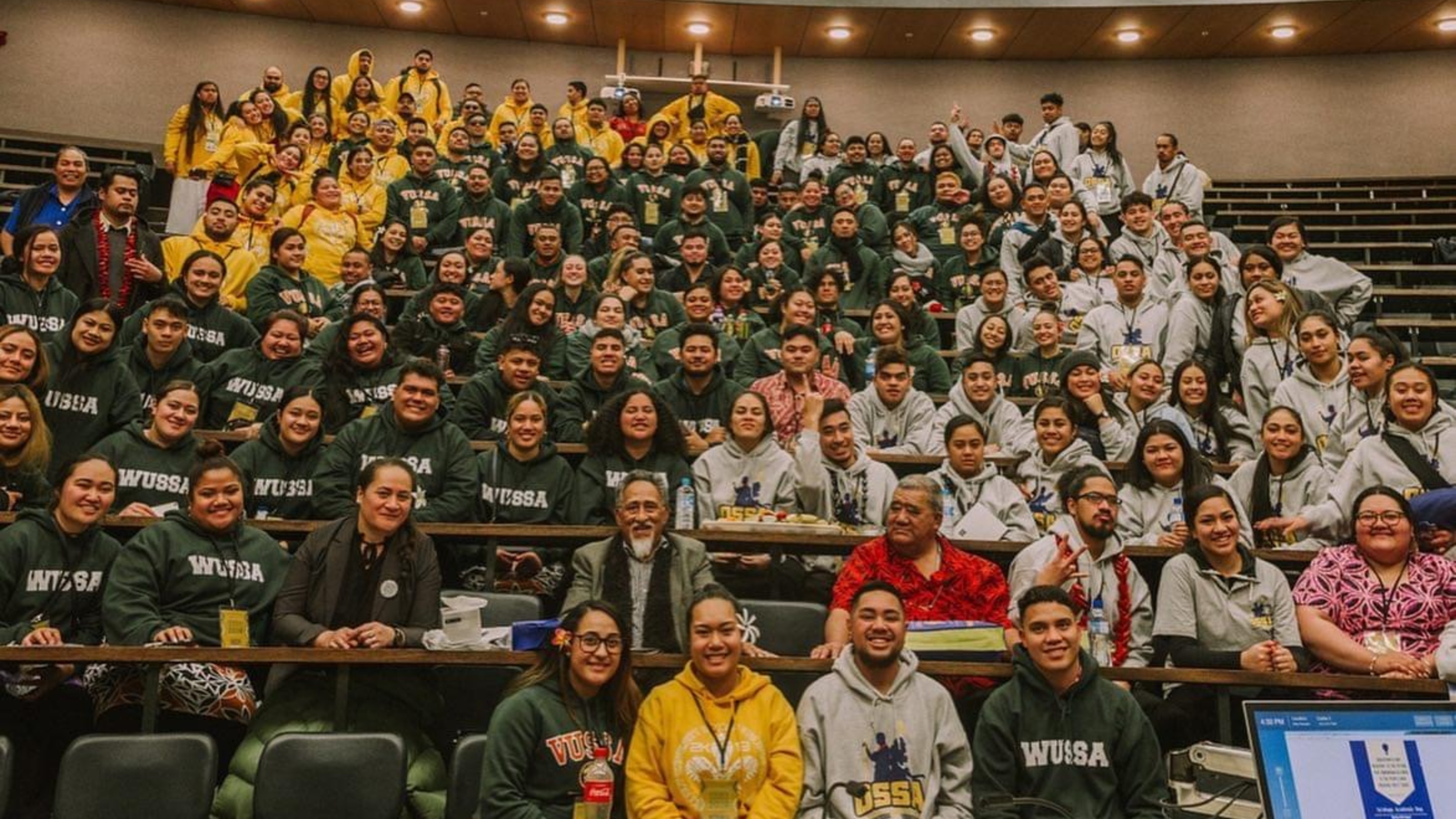 VUSSA members wearing branded hoodies in lecture theatre.
