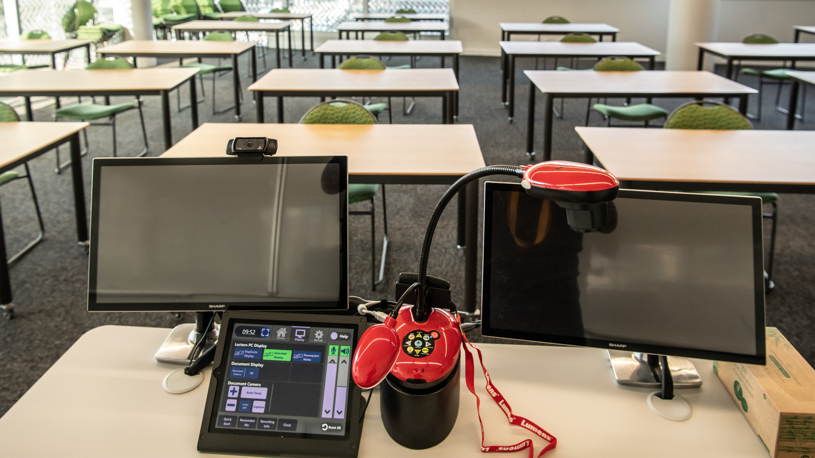 Equipment in Rutherford House seminar room. desk light, screens, and touchscreen controls are visible