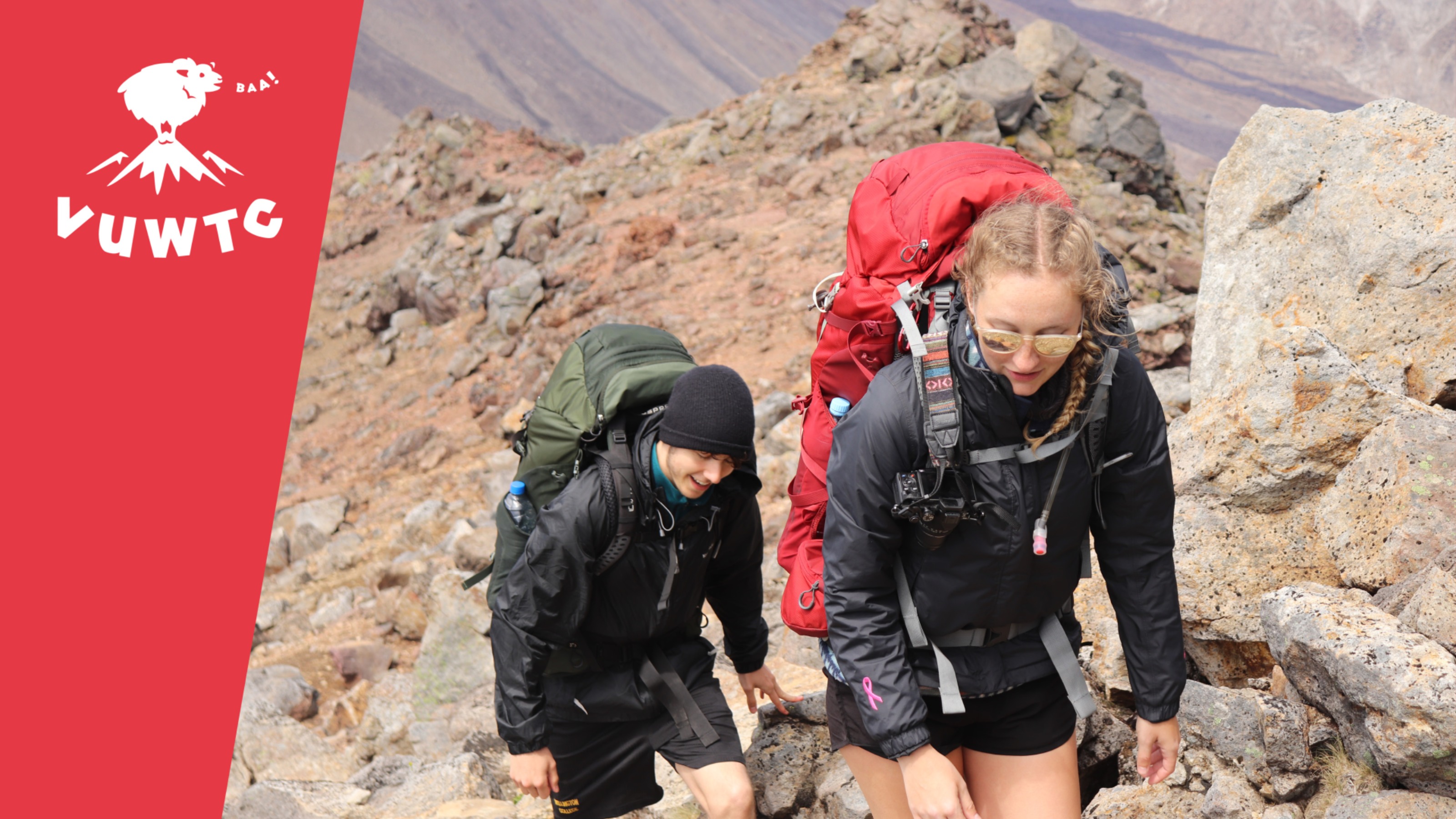 Two trampers walking on steep rocky road.