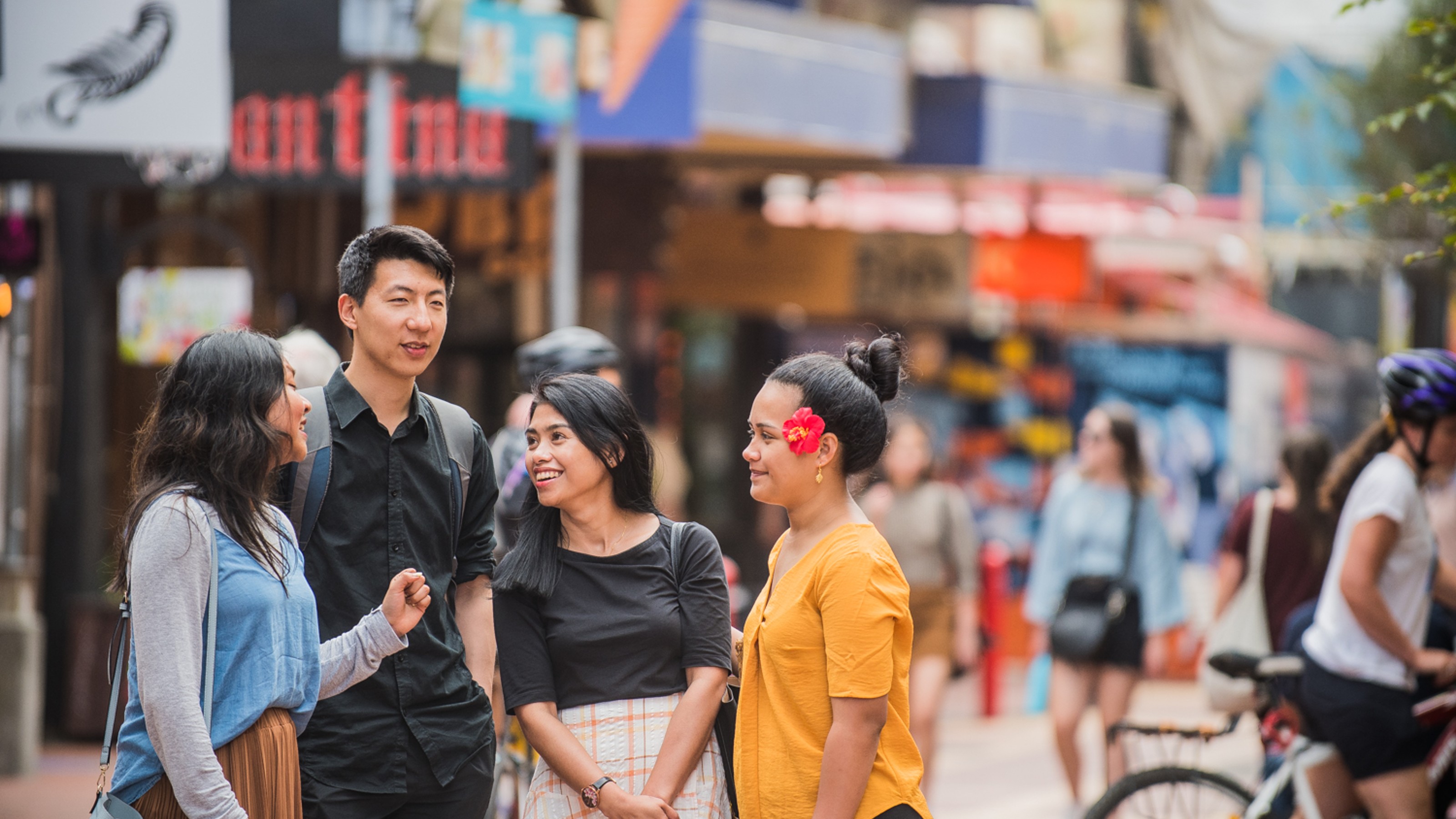 Students in the middle of a colourful street deciding where to go