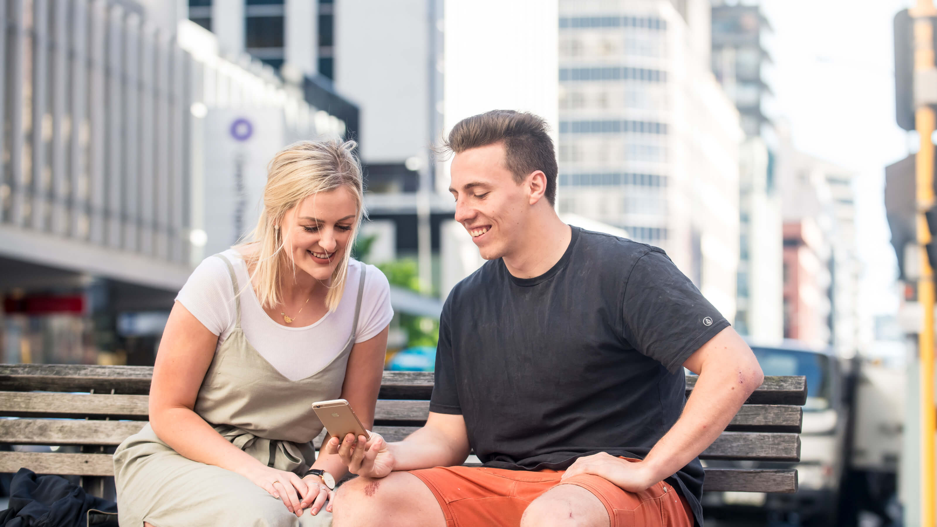 Students looking at a phone together on Lambton quay.