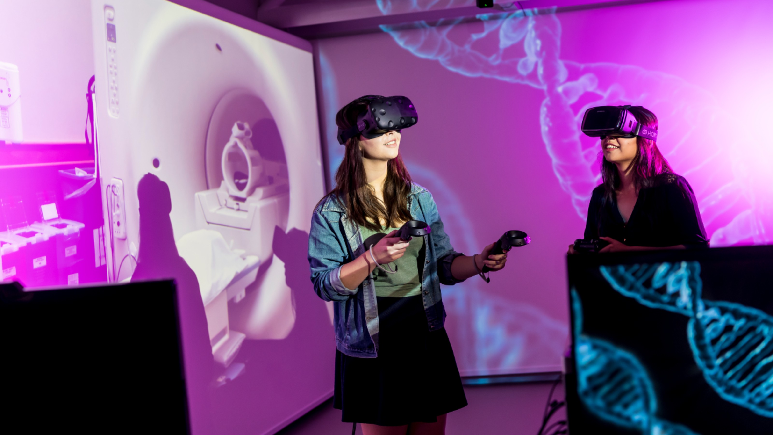 Two students explore the genome double helix on their VR headsets.
