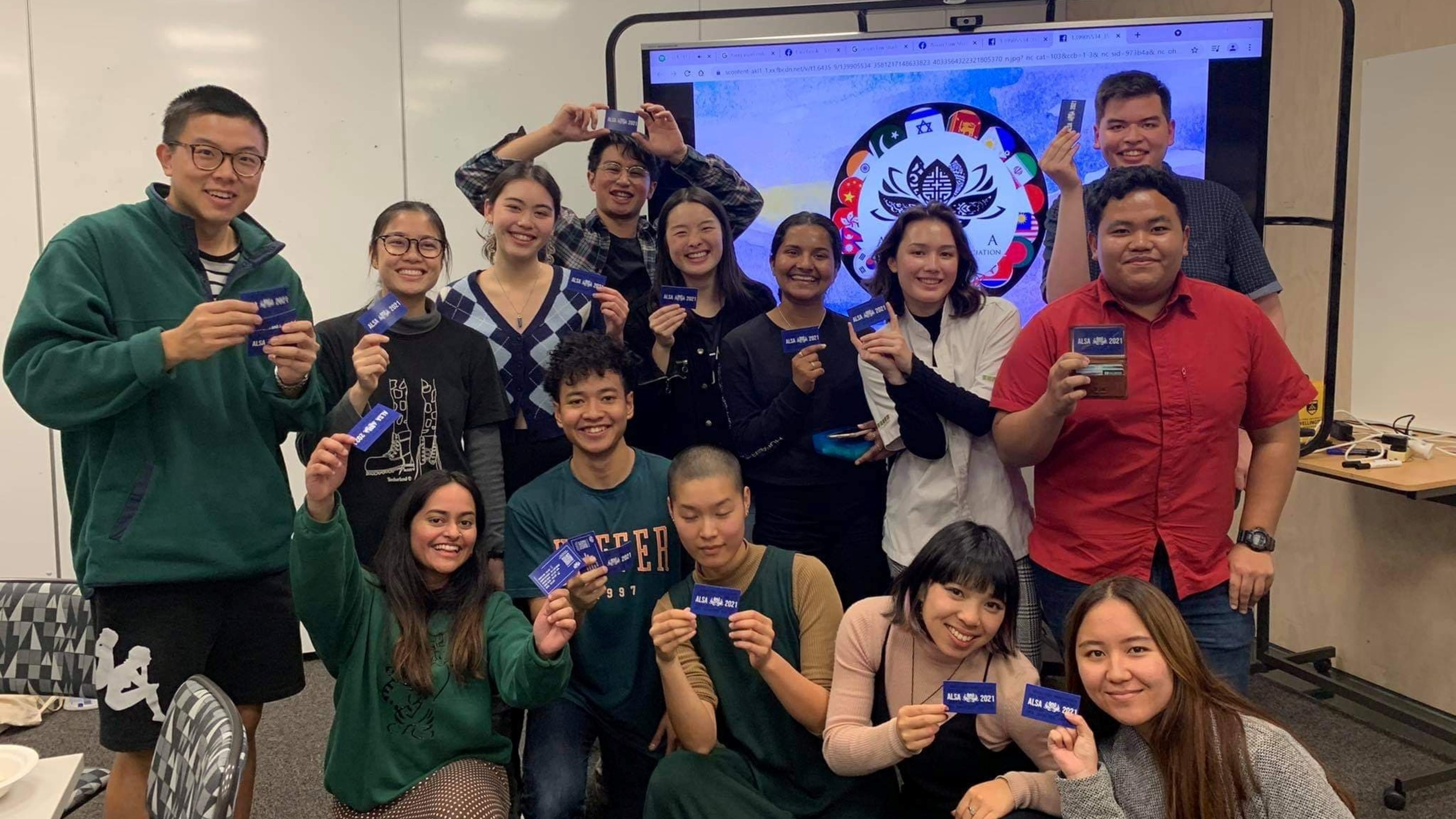 Group picture of members holding out their membership cards.
