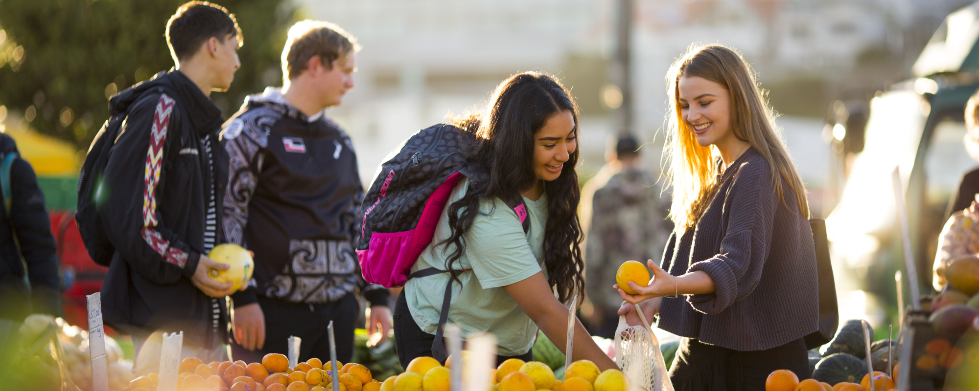 Two female students shopping for fruit at vegetable markets