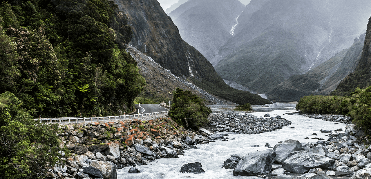 MSC Environmental Sciences - an image of a river flowing down a valley between two mountains.