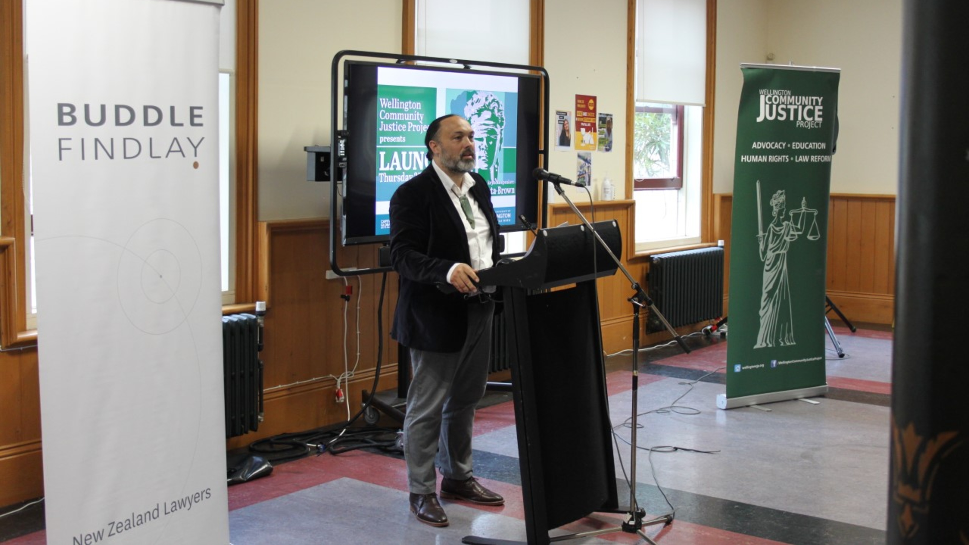 Guest speaker standing at lectern during event.