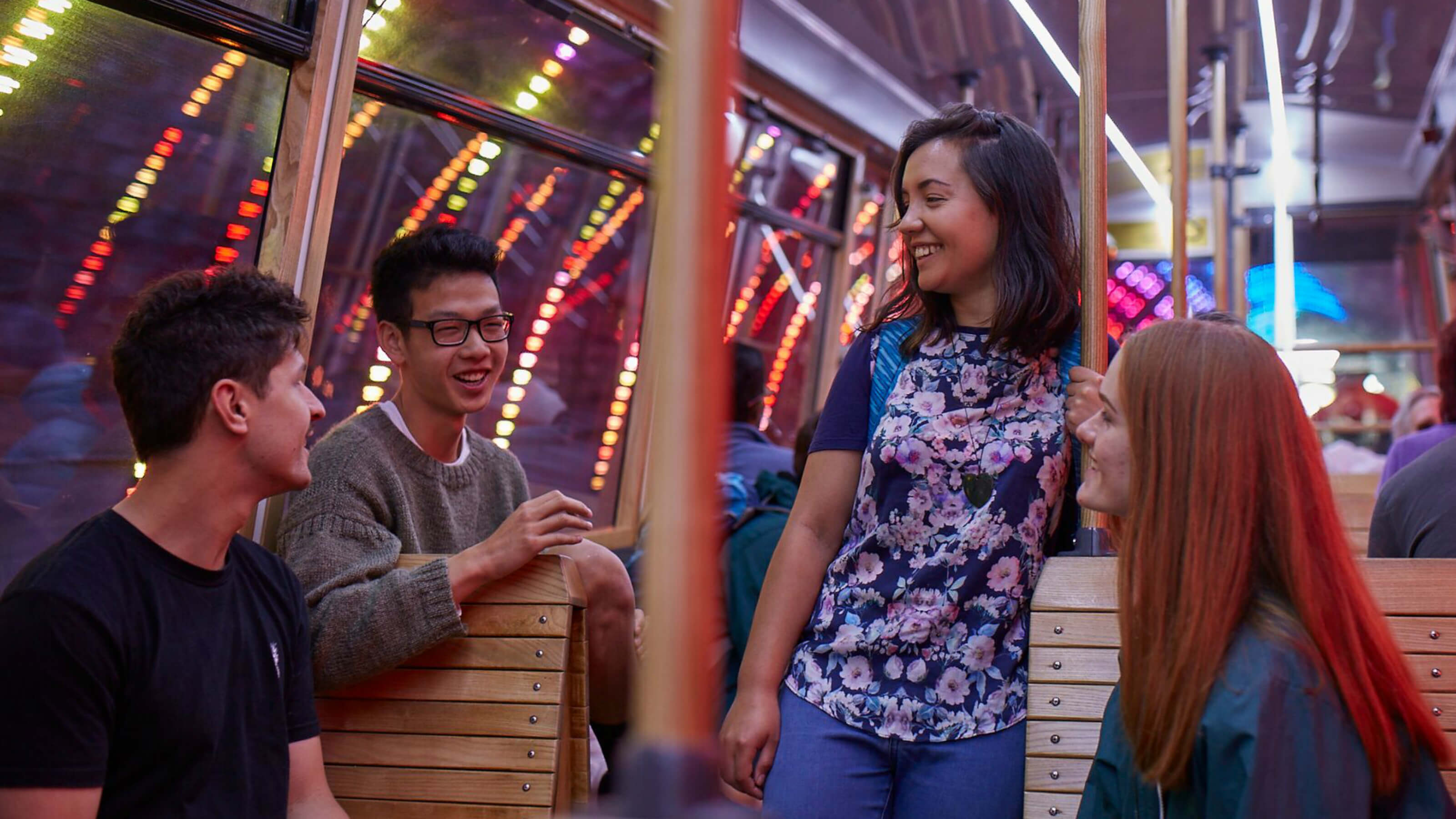 Four university students talking on the cable car in Wellington.