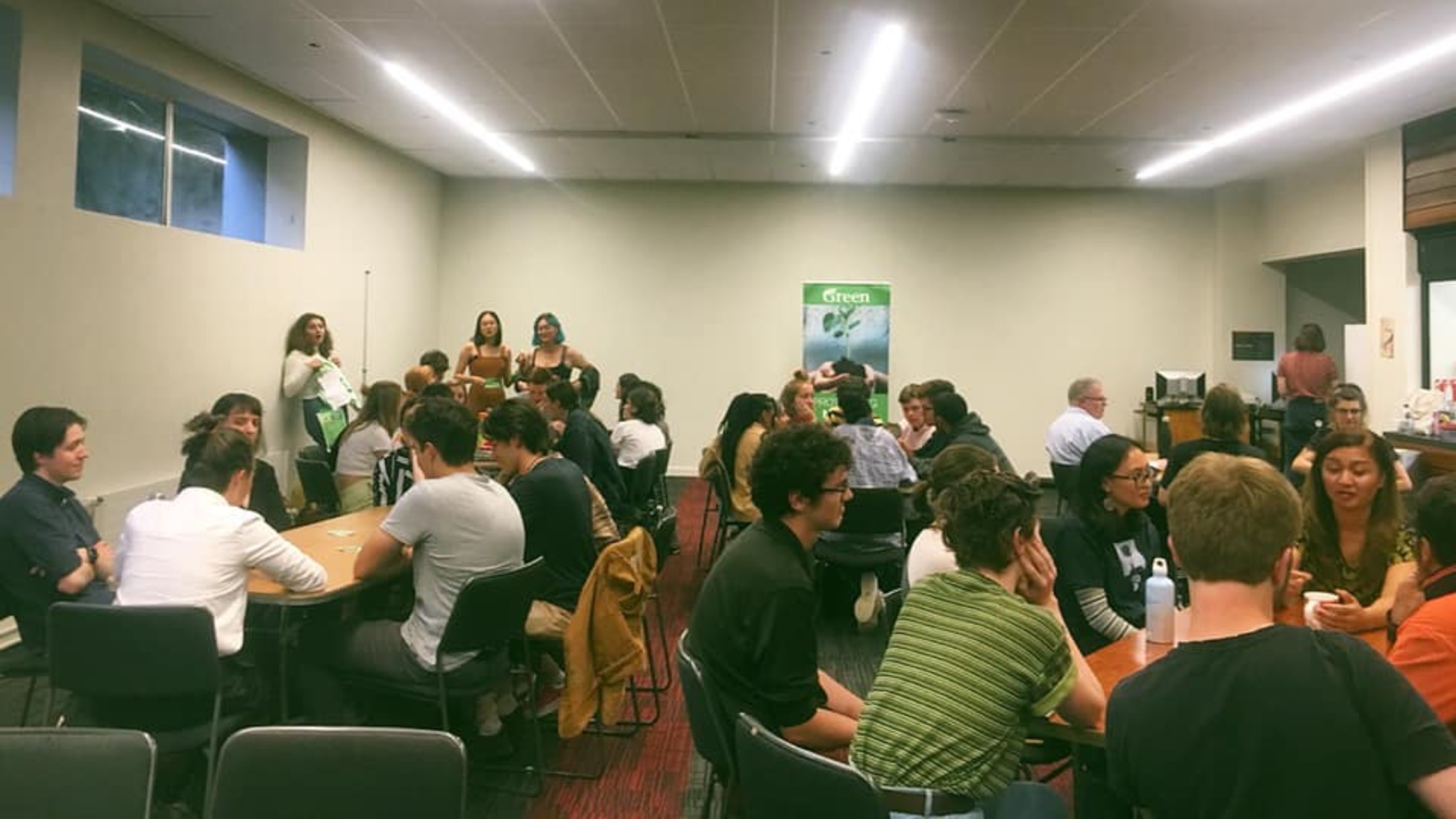 Greens@VIC members sitting at table during potluck.