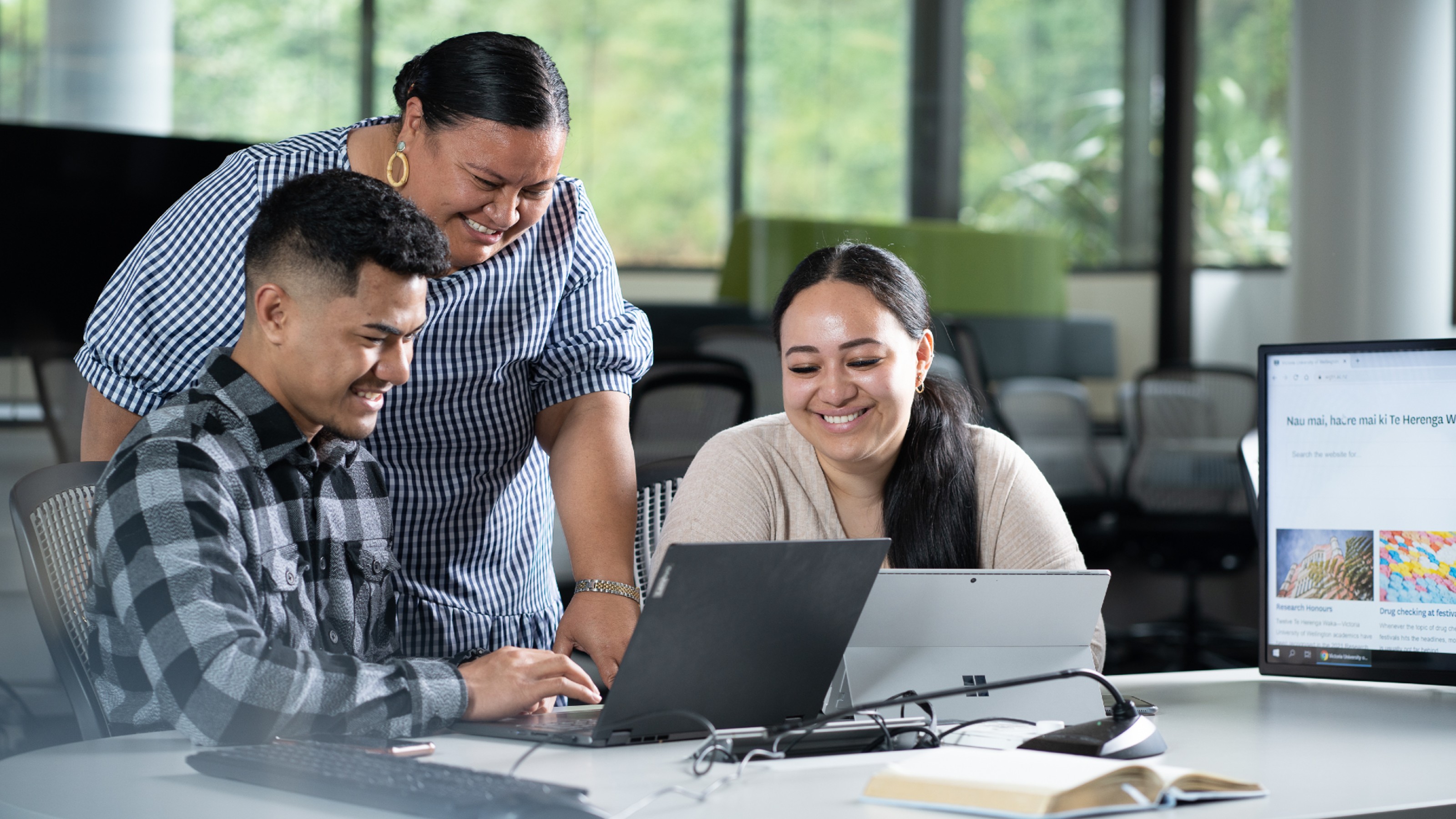 Three people working together on laptops